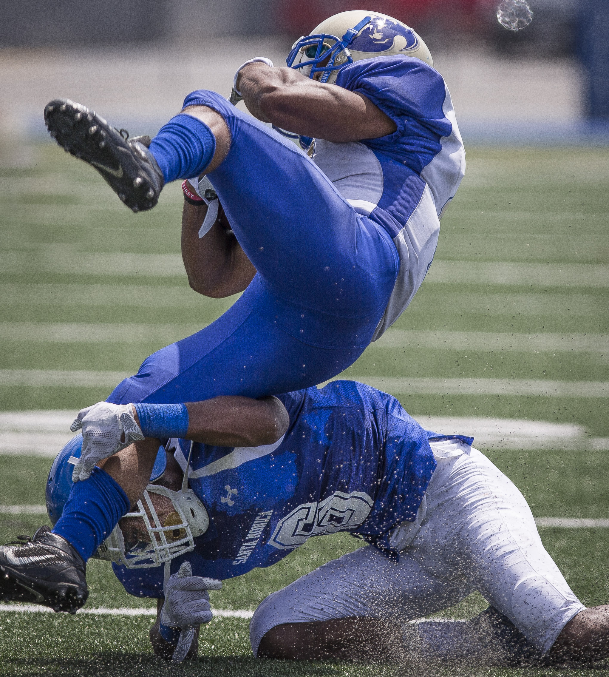  The Santa Monica College Corsairs Mens football Team defensive back Tyree Fryer (23) (blue,bottom) makes a tackle against The West La College Wildcats running back Drexel Mosby (white,top) (11), Friday, September 2nd, 2017, at West La College in Cul