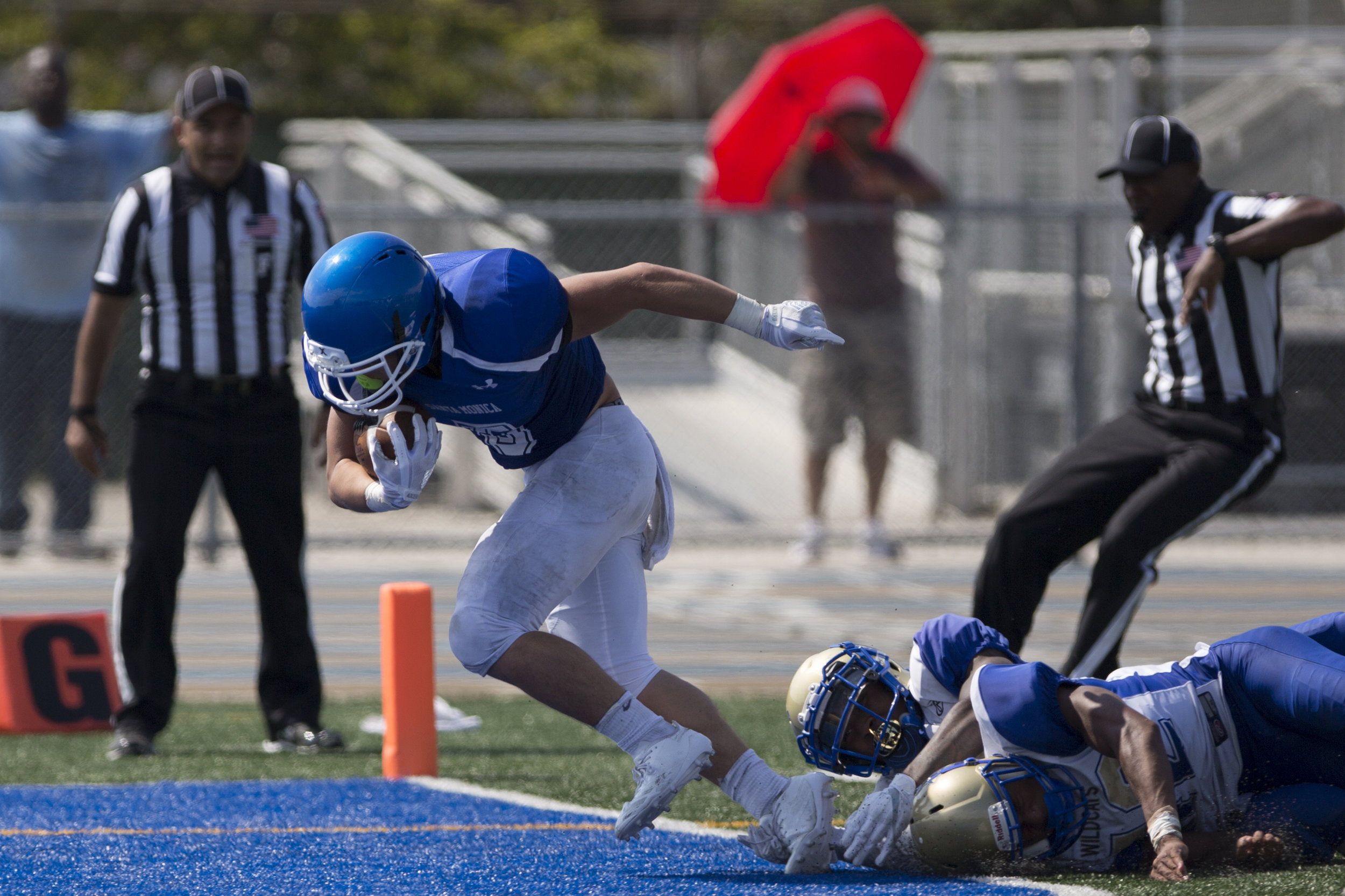  Santa Monica Corsair Christoph Hirota (5)(left) breaks a tackle from West Los Angeles Wildcats Aaron Brown (7)(center) and Alexander Johnson (42)(right) to score a touchdown during the third quarter on September 2, 2017 at West Los Angeles College i