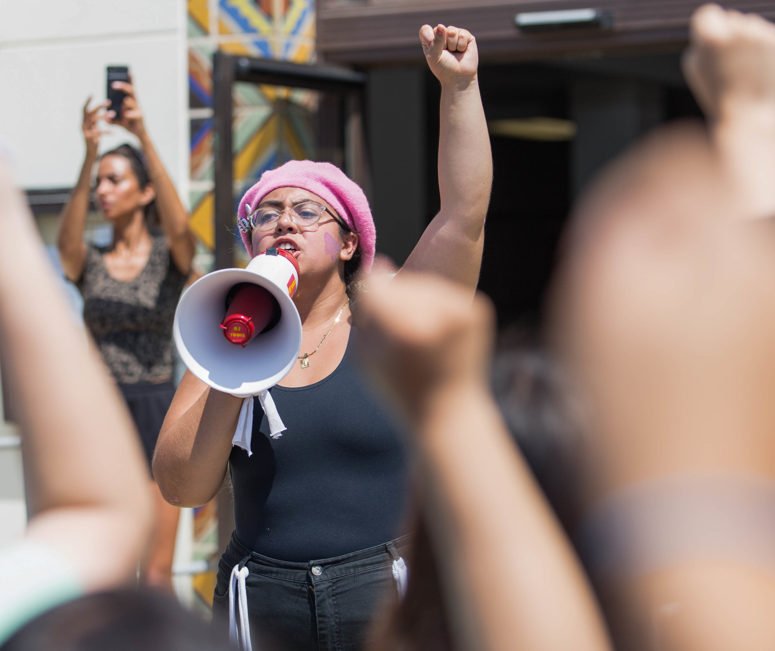  Estephanie Guardudo uses her Megaphone to ask protestors to raise their fist, symbolizing the strength they have on the steps of Santa Monica City Hall, Santa Monica, Calif. Estephanie wants members of City Hall to know their protests are strong and