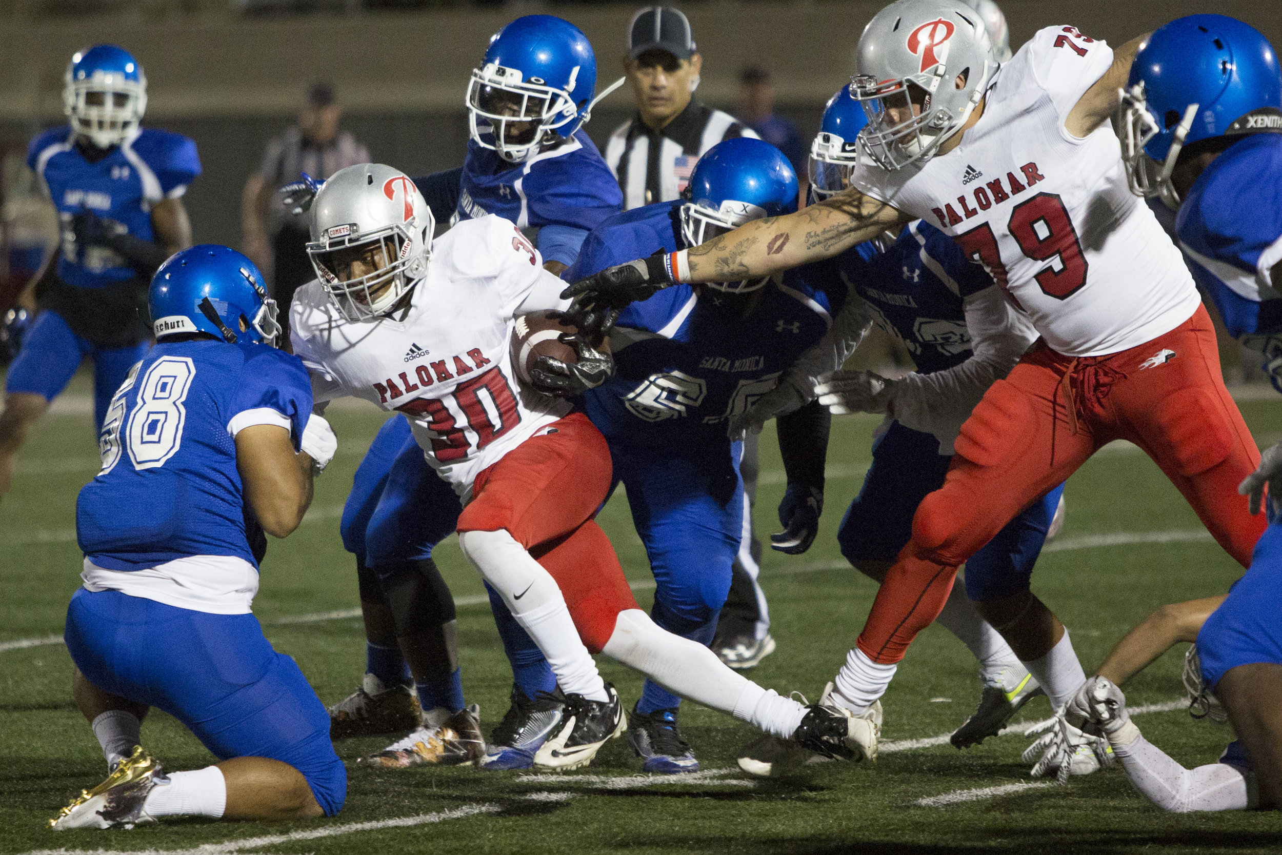 Palomar College Comet Edwin Morton (RB)(30)(left) struggles to break free from a tackle by the Santa Monica College Corsairs on September 10, 2017 on the Corsair Field at Santa Monica College in Santa Monica, California. The Corsairs lose to the Com