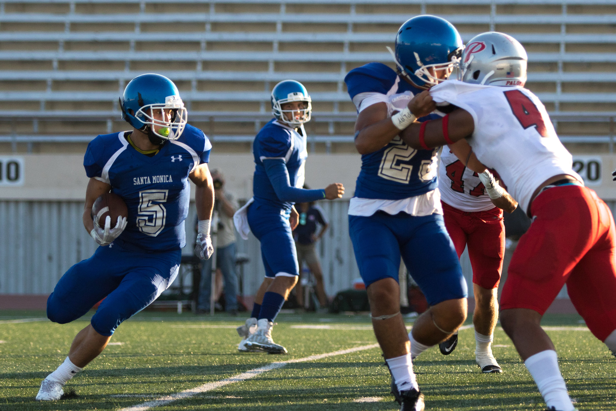  Santa Monica College Corsairs Freshman Running Back Christoph Hirota (5, left) runs the ball upfield as fellow Freshman Running Back Trevor Nofoa (23, middle) applies a block. The Corsairs were defeated 45-14 at the Santa Monica College Field on the