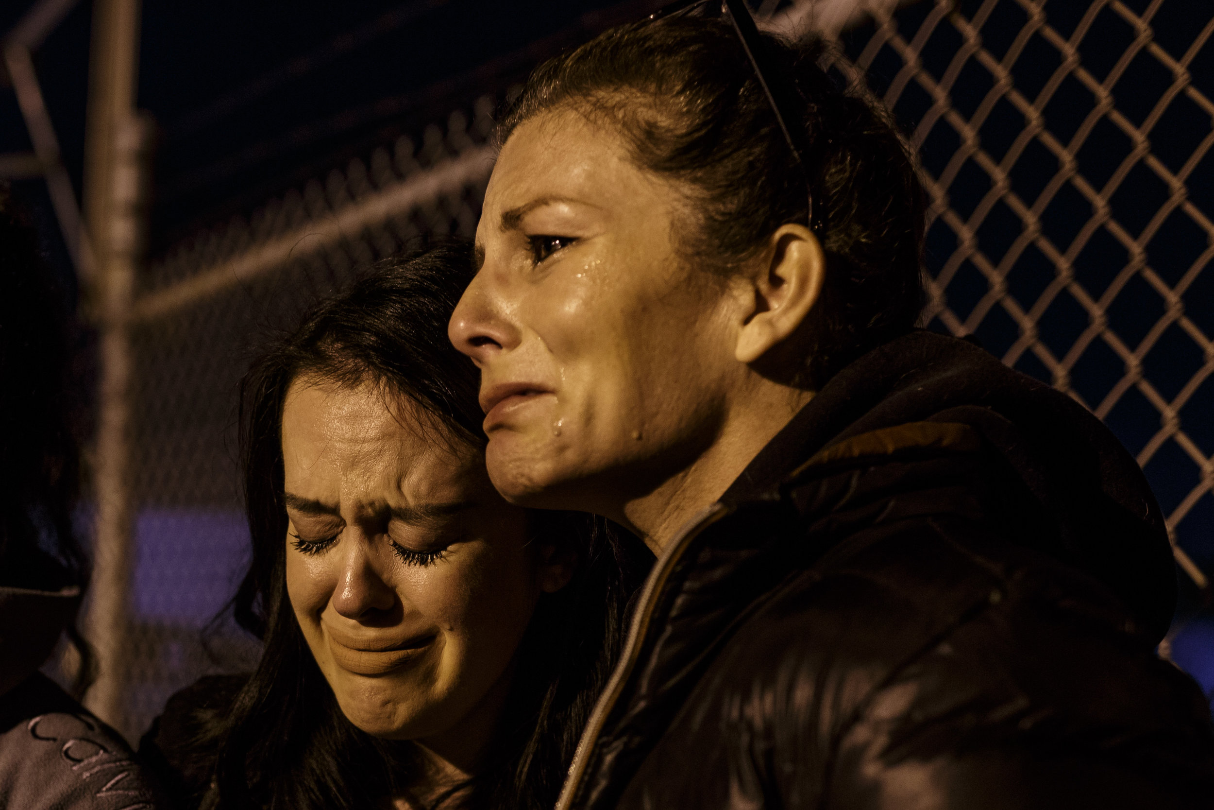  Jo McGuinness comforts Michelle Hill at a vigil for pigs held outside Farmer John, a slaughterhouse in Vernon, CA. Michelle recently became vegan and reconnected with Jo over social media - this is her first time at a vigil. March 22nd 2017 photo by
