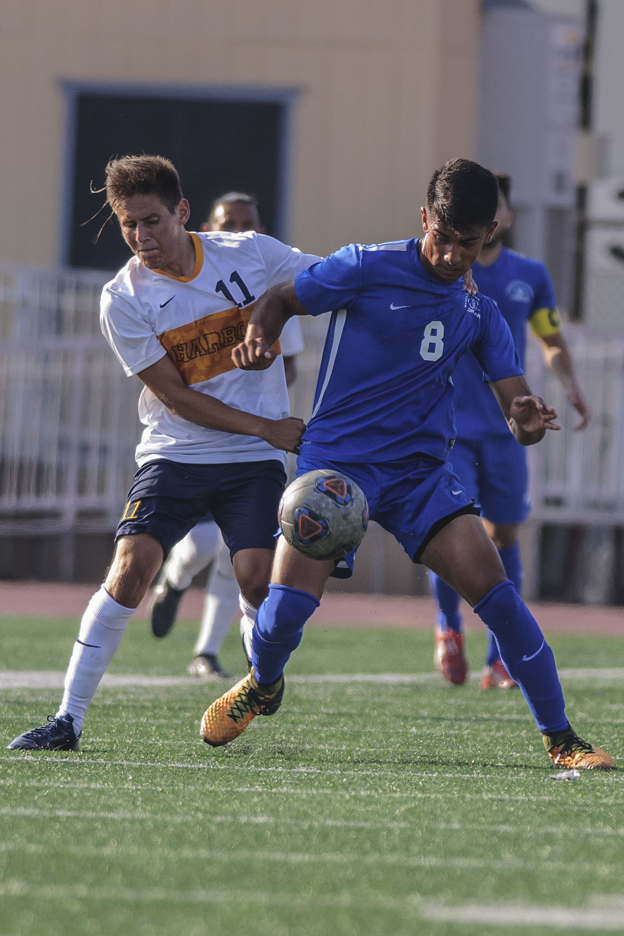  Left Jose Cuevas from the Los Angeles Harbor College mens soccer team grab hold Andy Naidu from the Santa Monica College mens soccer team as Nadiu dribbles the soccer ball down field at Corsair Field located on the campus of Santa Monica College on 