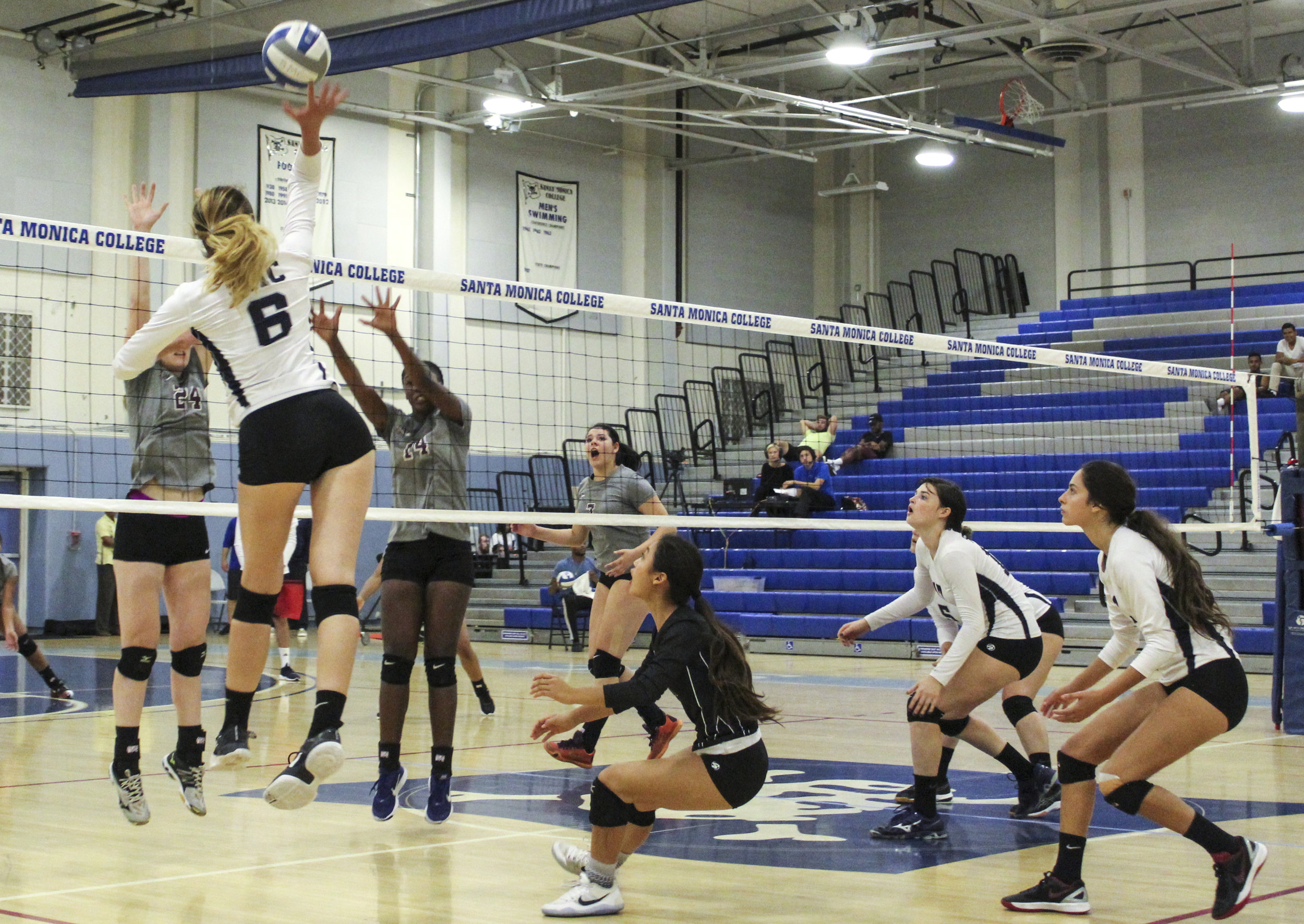  SMC women’s volleyball Outside Hitter (OH) Chelsea Bostwick  (#6, far left, blue and white) goes up for the kill against a Marauder defense that repeatedly had little counter against the “bombs away” style of the Corsair attack during the match at  