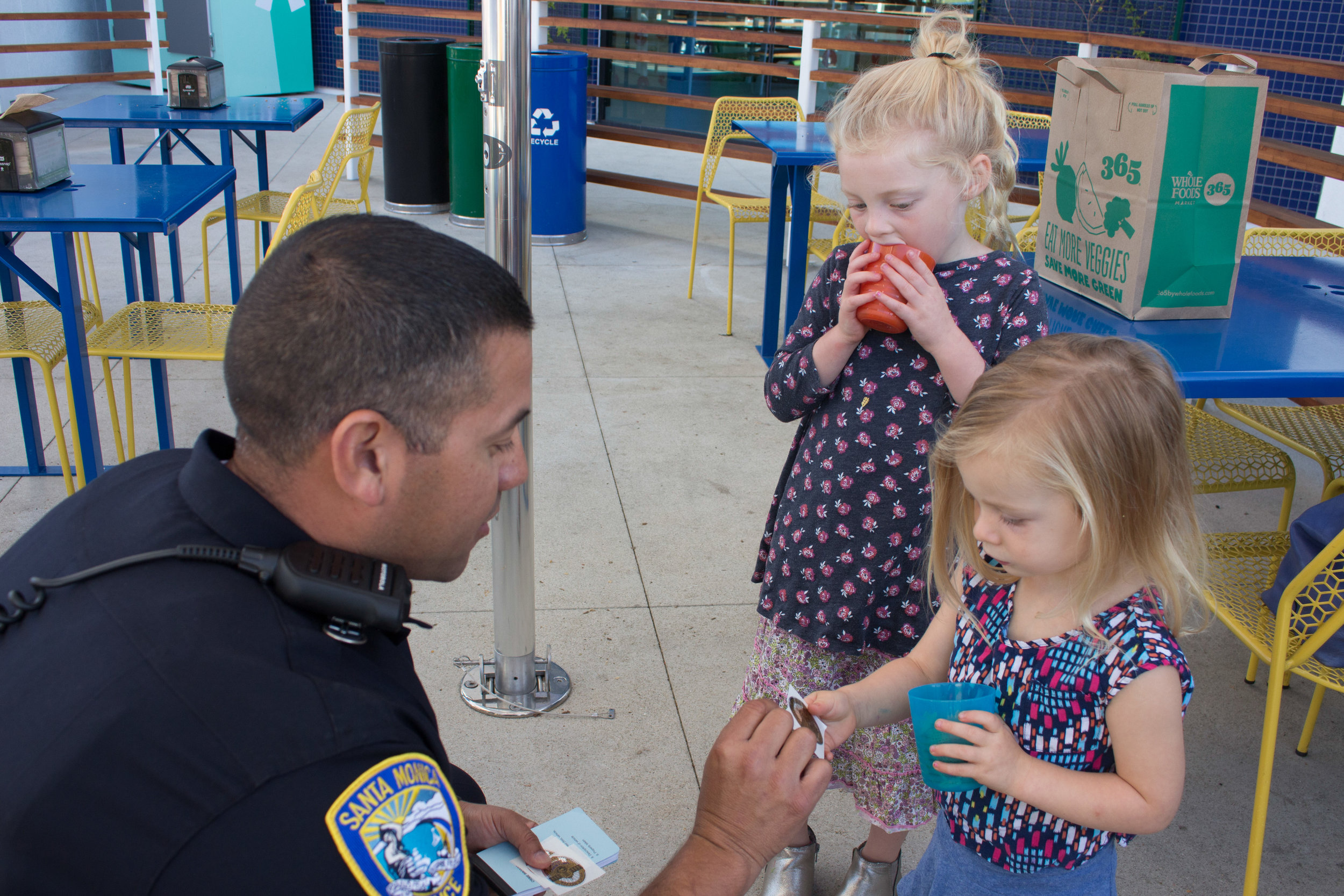  Officer Gustavo Cortez (left) gives two year old Sienna Robertson (right) a Police Helper sticker during National Coffee with a Cop Day held at Groundwork on Wednesday, October 4, 2017, in Santa Monica, Calif. This event began in 2011 to help promot