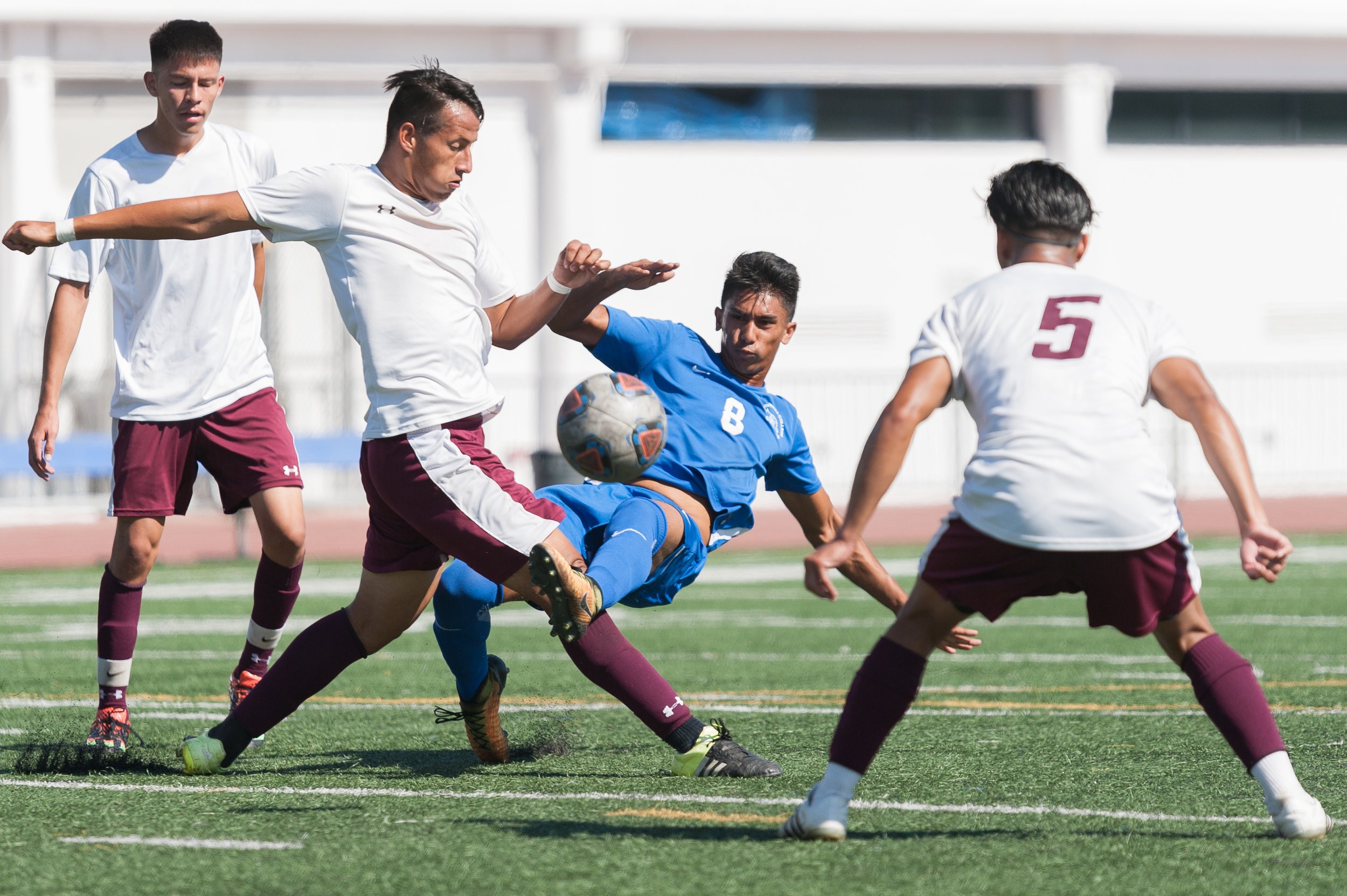  Forward Andy Naidu (8) of Santa Monica College makes a pass through several Victor Valley players. The Santa Monica College Corsairs won the game 2-0 against the Victor Valley Rams. The match was held at the Corsair Stadium at Santa Monica College i