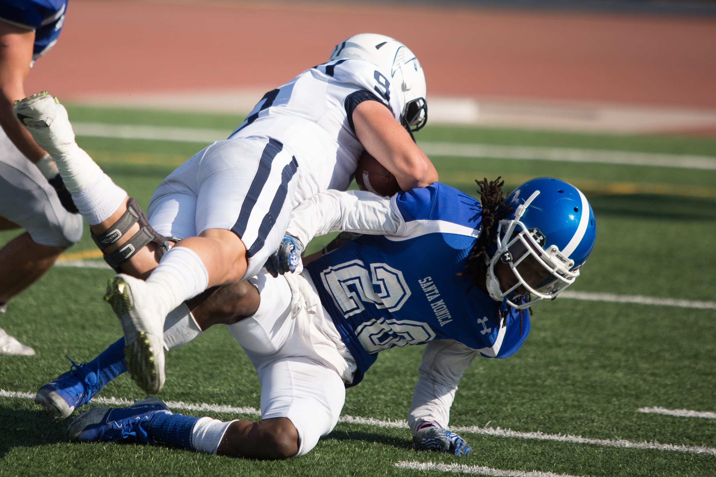  Difensive back Tyler Cater (20) of Santa Monica College attempt to stop Placekicker Fernando Buenabad (9) of Cerritos College. The Santa Monica College Corsairs lose the game 7-31 against Cerritos Falcons on Saturday, October 14th, 2017 at the Corsa