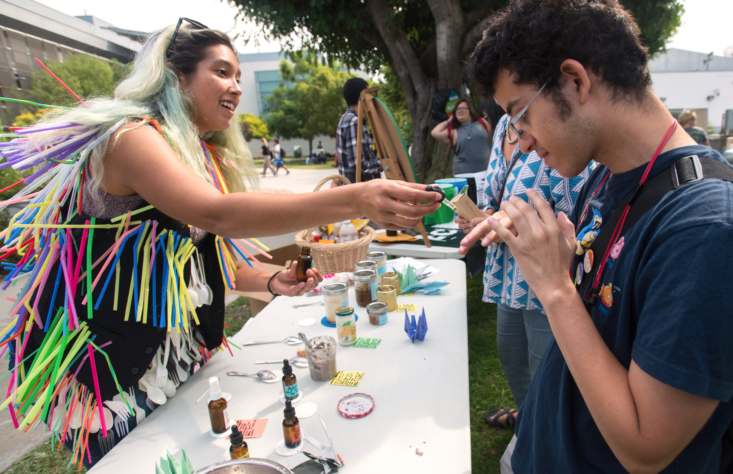  Carla Claure, 28, (L) Vice President of Eco Action club demonstrates oil samples for men to Anthony Carrillo, 20, (R) a Psychology major during Sustainability Week at Santa Monica College, in Santa Monica, California on October 17, 2017. (Josue Mart