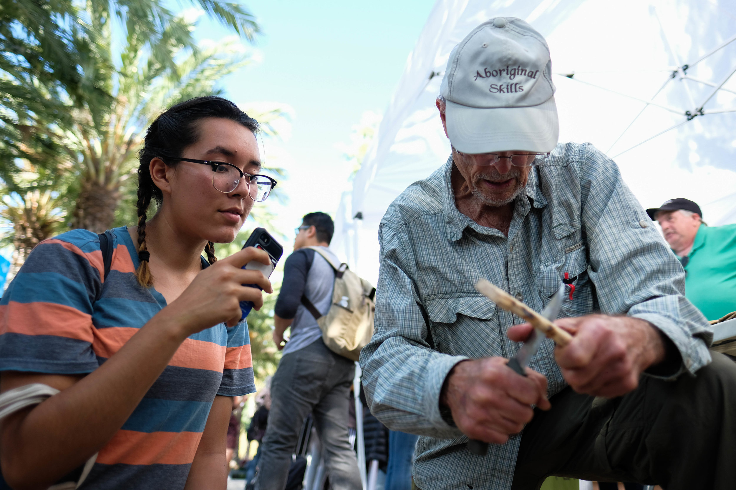  At the Santa Monica College Sutainability week,Cinthya Vazquez, a environmental science major learns to create a hearth for a primitive fire hand drill. The hearth represents the female as the drill represents the male. "The combiniation of the two 