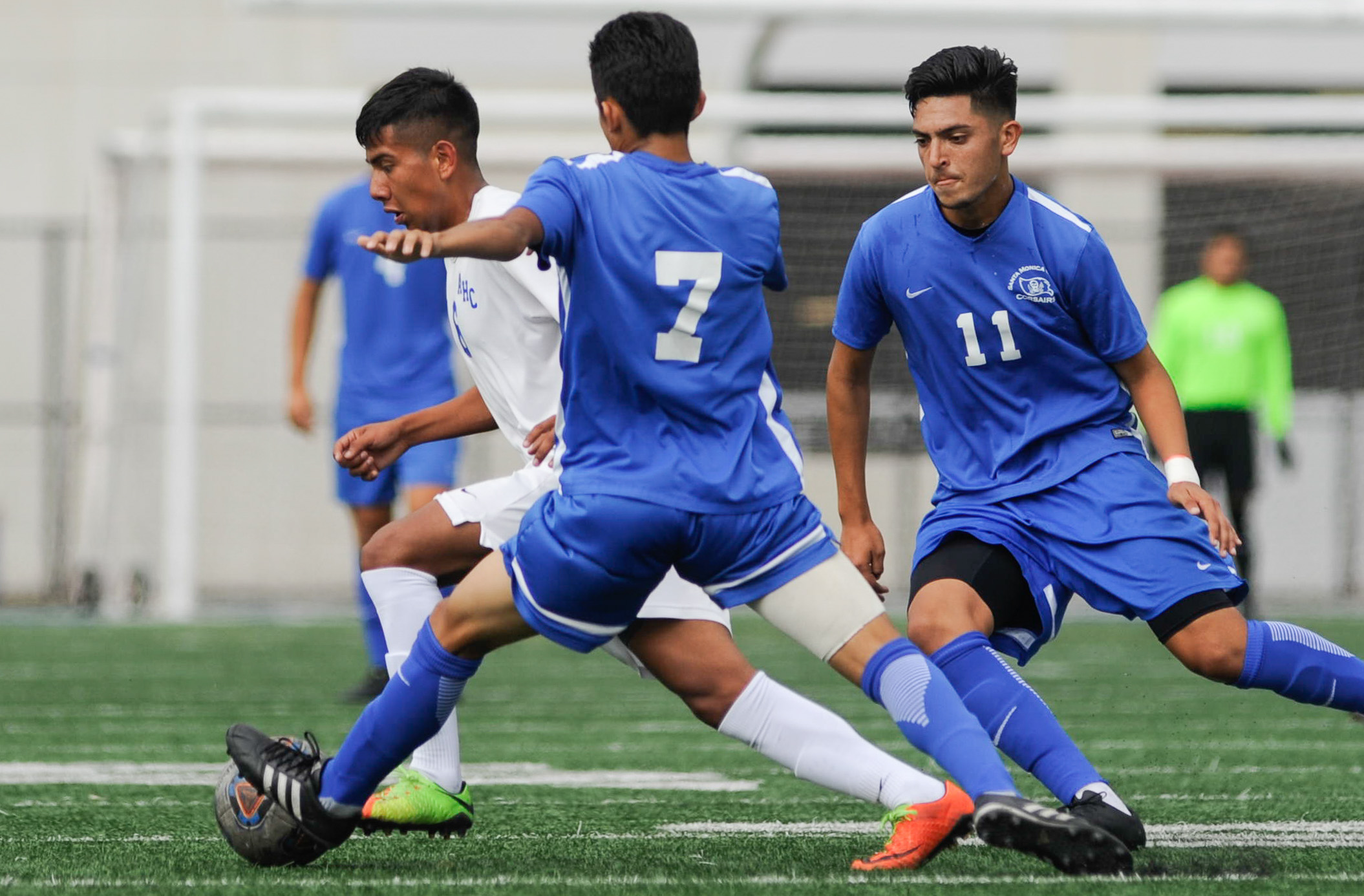  Midfielder Danny Hernandez (11,Right) and Kevin Martinez (7,Middle) of Santa Monica College attempt to contest midfielder Francisco Ayala (6,Left) of Allan Hancock College. The Santa Monica College Corsairs end the game tied with the Allan Hancock C