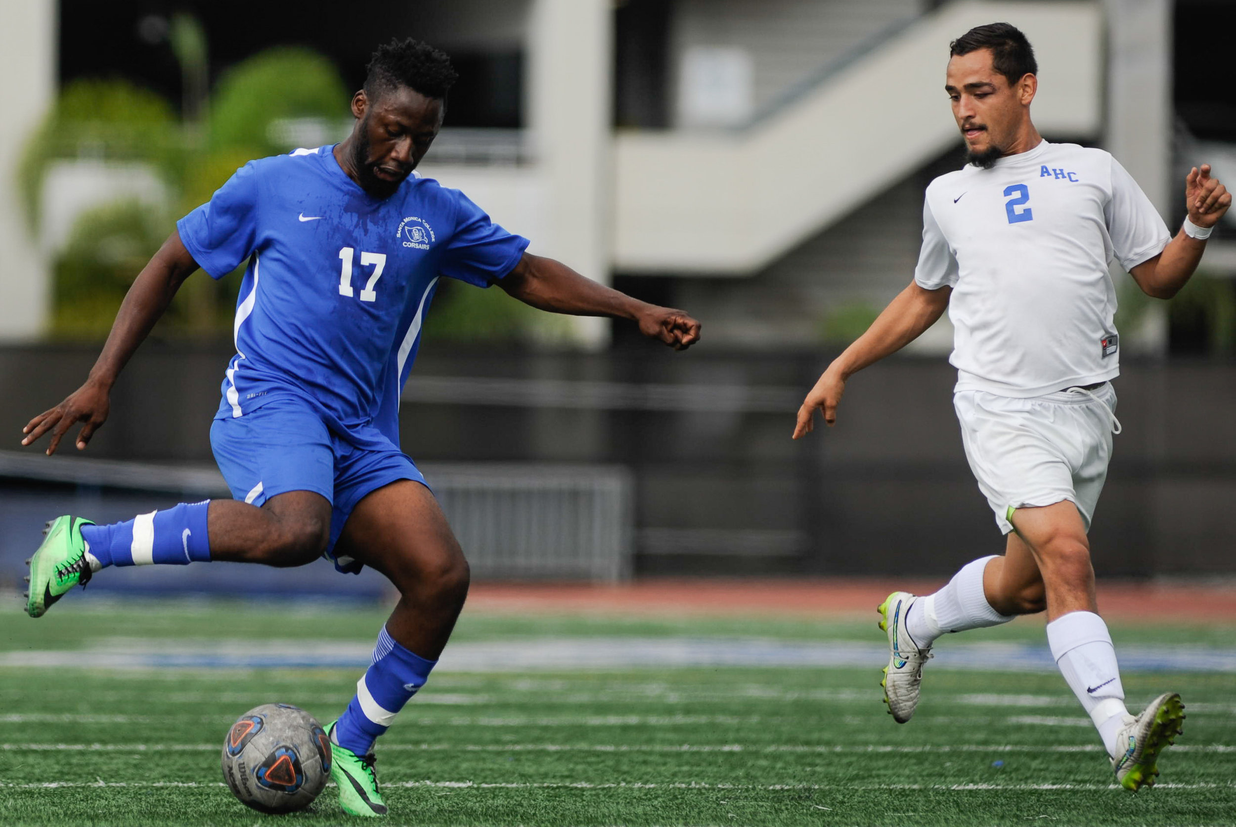  Midfielder Cyrille Njomo (17) of Santa Monica College fakes a pass while being guarded by defender Mario Delgado (2) of Allan Hancock College. The Santa Monica College Corsairs end the game tied with the Allan Hancock College Bulldogs 1-1. The match
