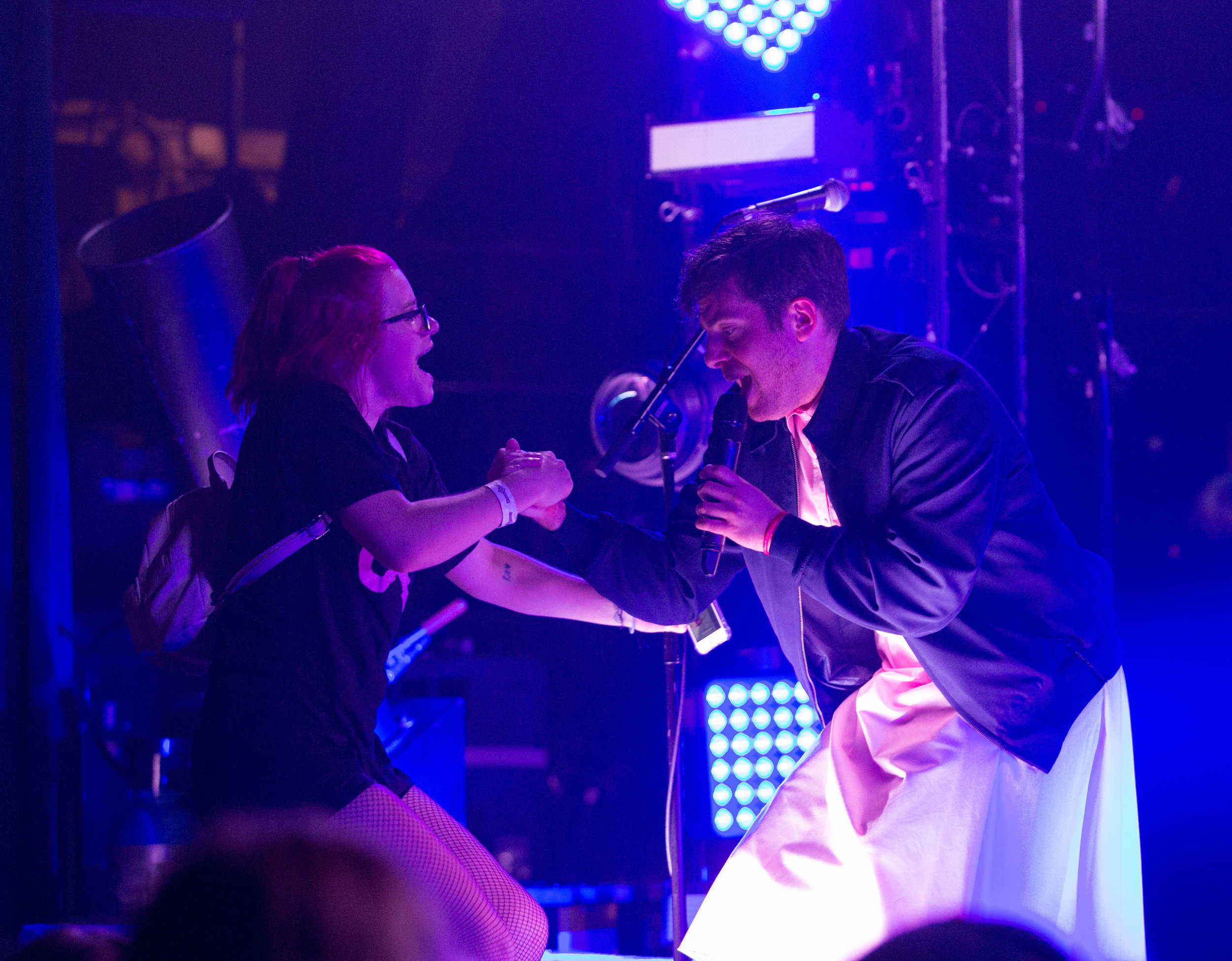  American rapper Hoodie Allen (Steven Adam Markowitz) helps a fan on stage after her phone was called by the rapper dressed as the female character "11" from the Netflix show "Stranger Things". The second season of the show released Friday, October 2