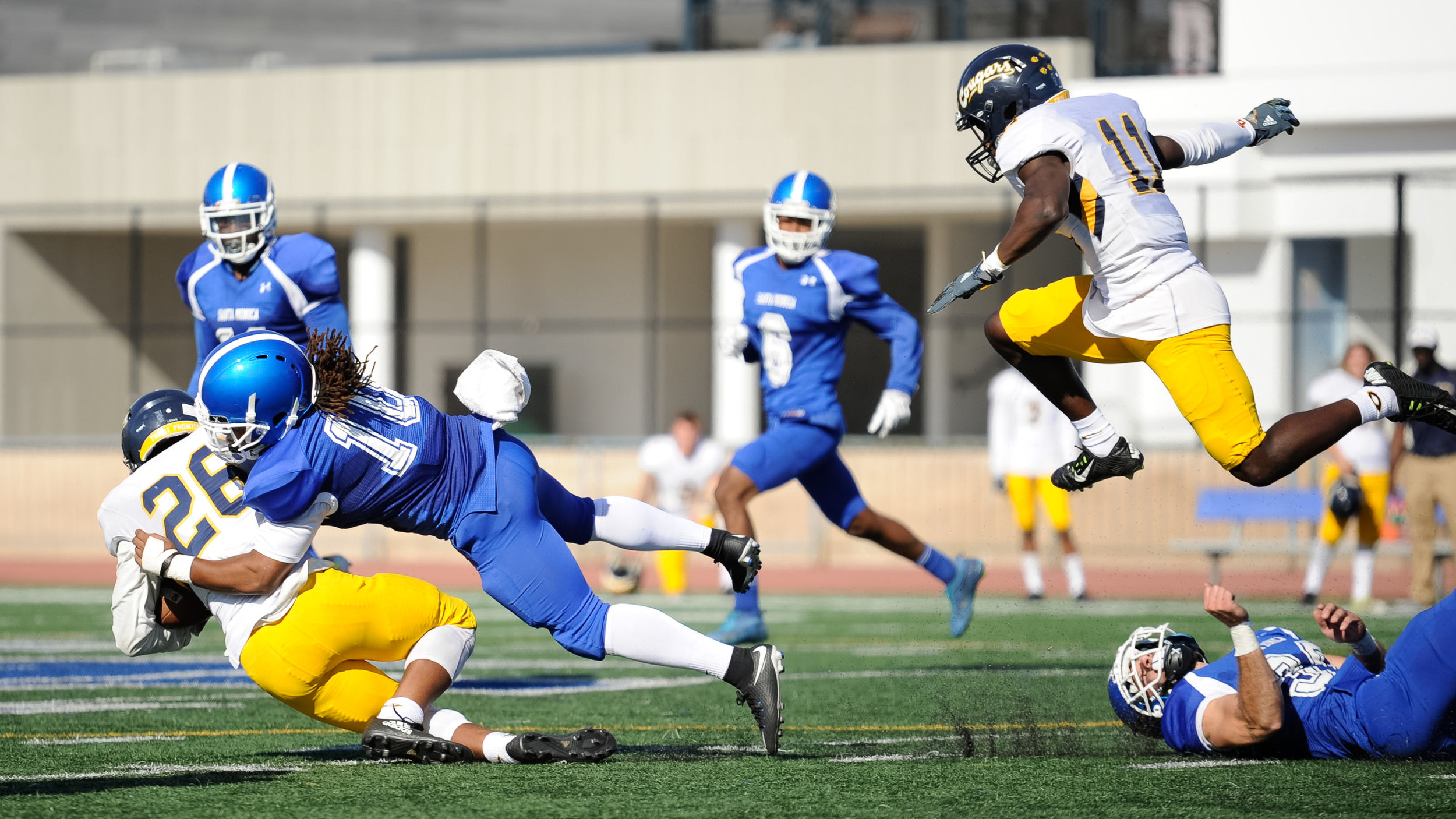  Linebacker Devin Cox (10,Middle) of Santa Monica College tackles running back Jalen Logan (26,Middle) of College of the Canyons ending the play. The Santa Monica College Corsairs lose their final home game 7-48 to the College of the Canyons Cougars 