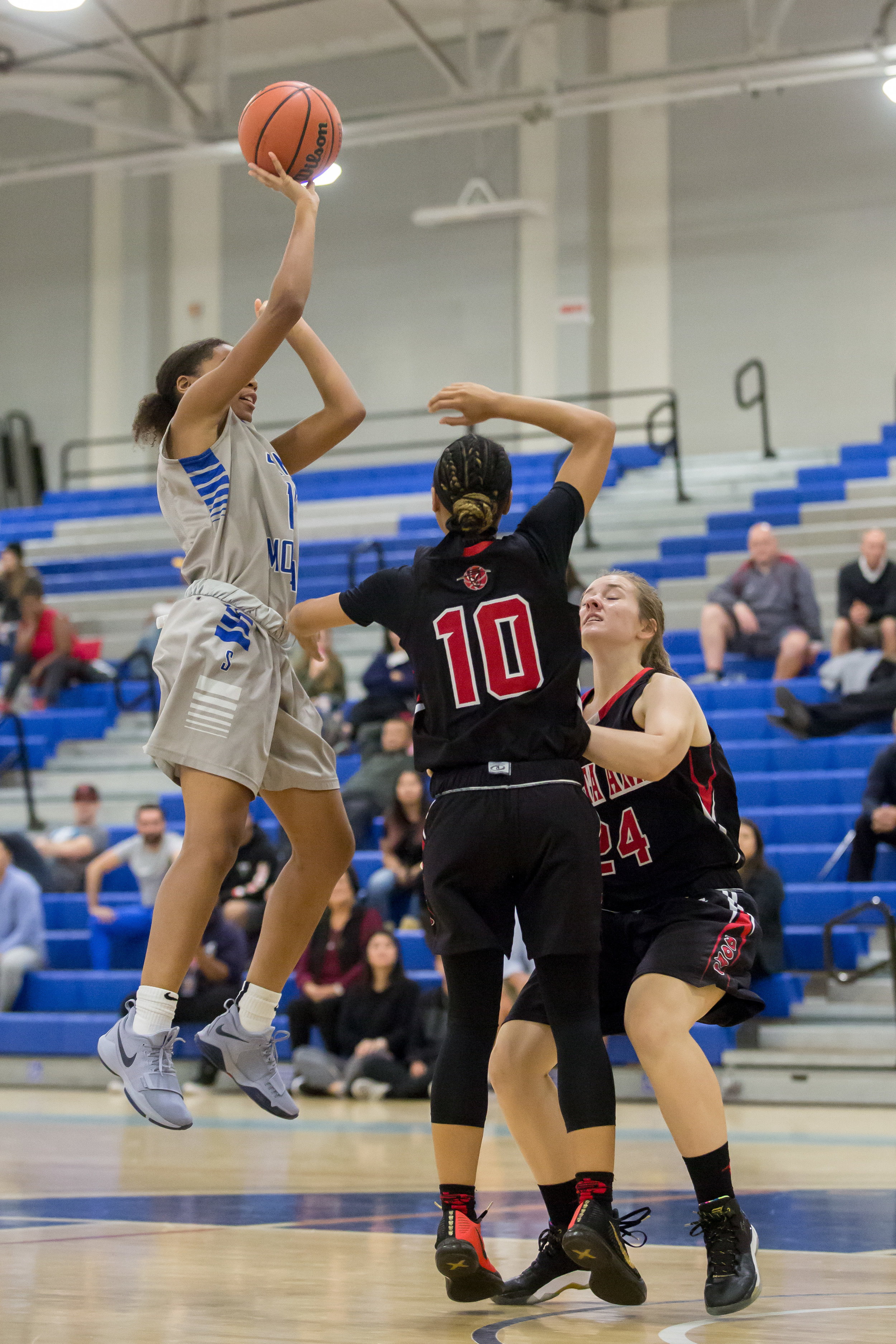  Forward Jazzmin Oddie (12) of Santa Monica College shoots a floater over  Guard Candace Black (10) and Guard Alexis Smith (24) of Santa Ana College. Santa Monica College Corsairs win the game 63-54 against Santa Ana College. On Saturday, November 4t