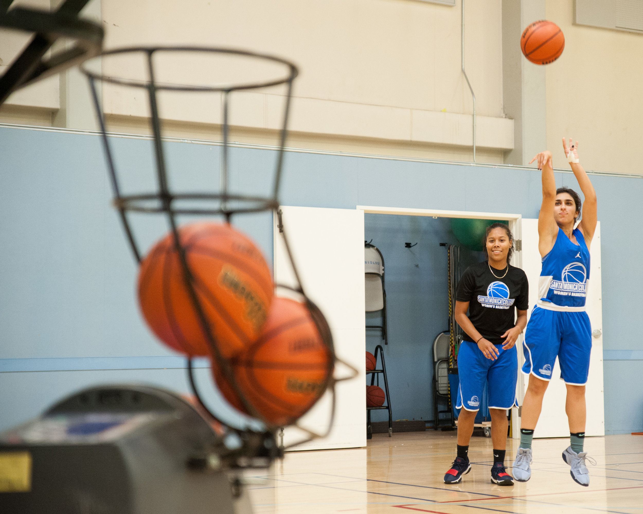  Sophmore guard Jessica Melamed (2) of the Santa Monica College Women's Basketball Team, shoots a three-pointer into a Dr. Dish machine during  practice at the SMC Pavilion. Melamed is currently leading the Corsairs in points per game in the first 2 