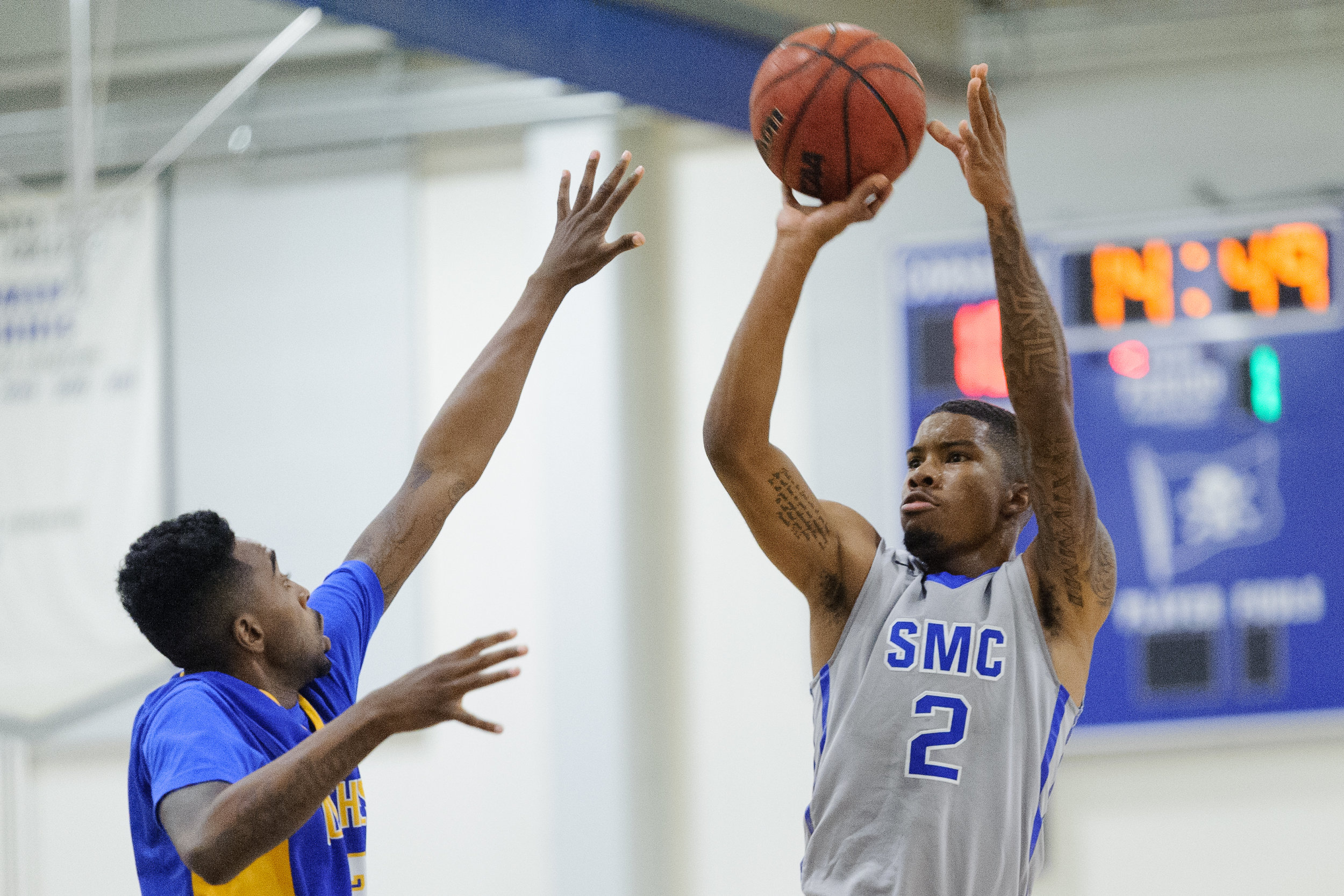  Guard Joe Robinson (2,Right) of the Santa Monica College takes a shot attempt while being contested by guard D’Lano Beckles (3,Left) of Southwest College. The Santa Monica College Corsairs win their first home game of the season 84-53 against the So