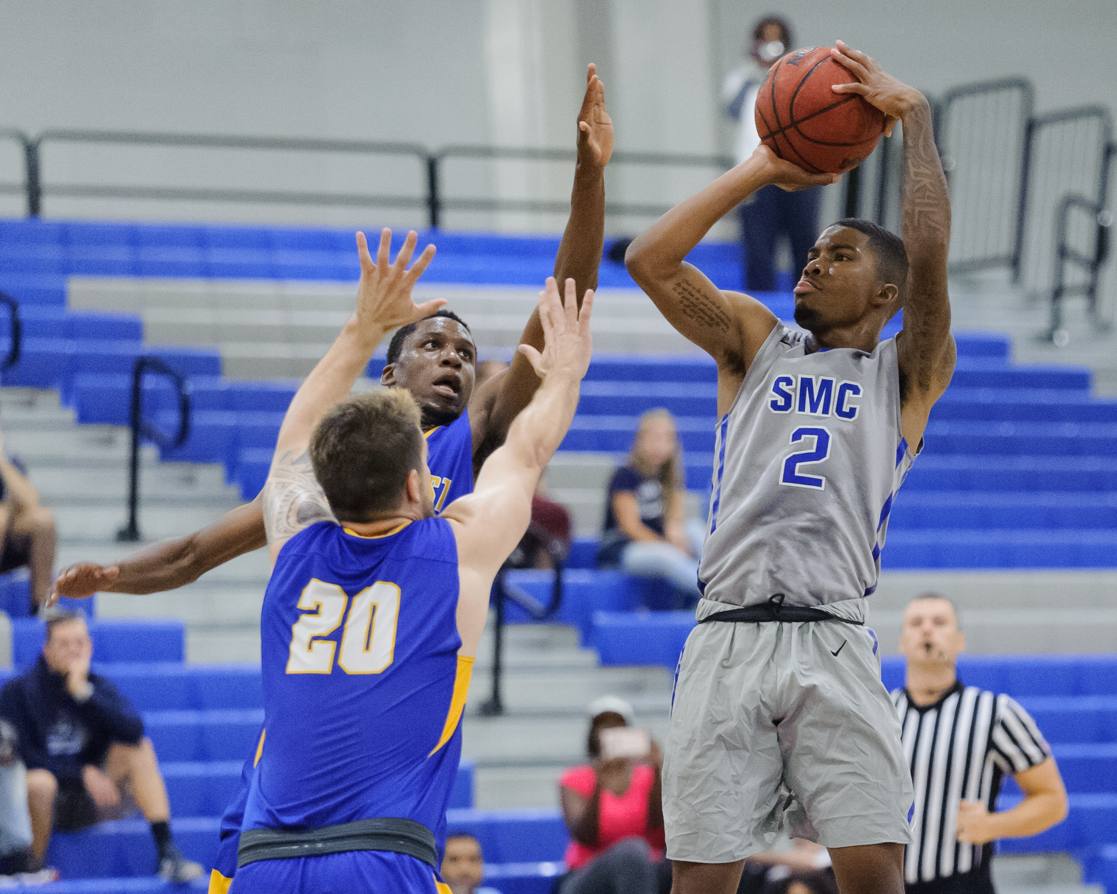  Guard Joe Robinson (2,Right) of the Santa Monica College takes a shot attempt while being contested by guards Austin Toomalatai (20,Left) and Kiza Sekiyoba (1,back) of Southwest College. The Santa Monica College Corsairs win their first home game of