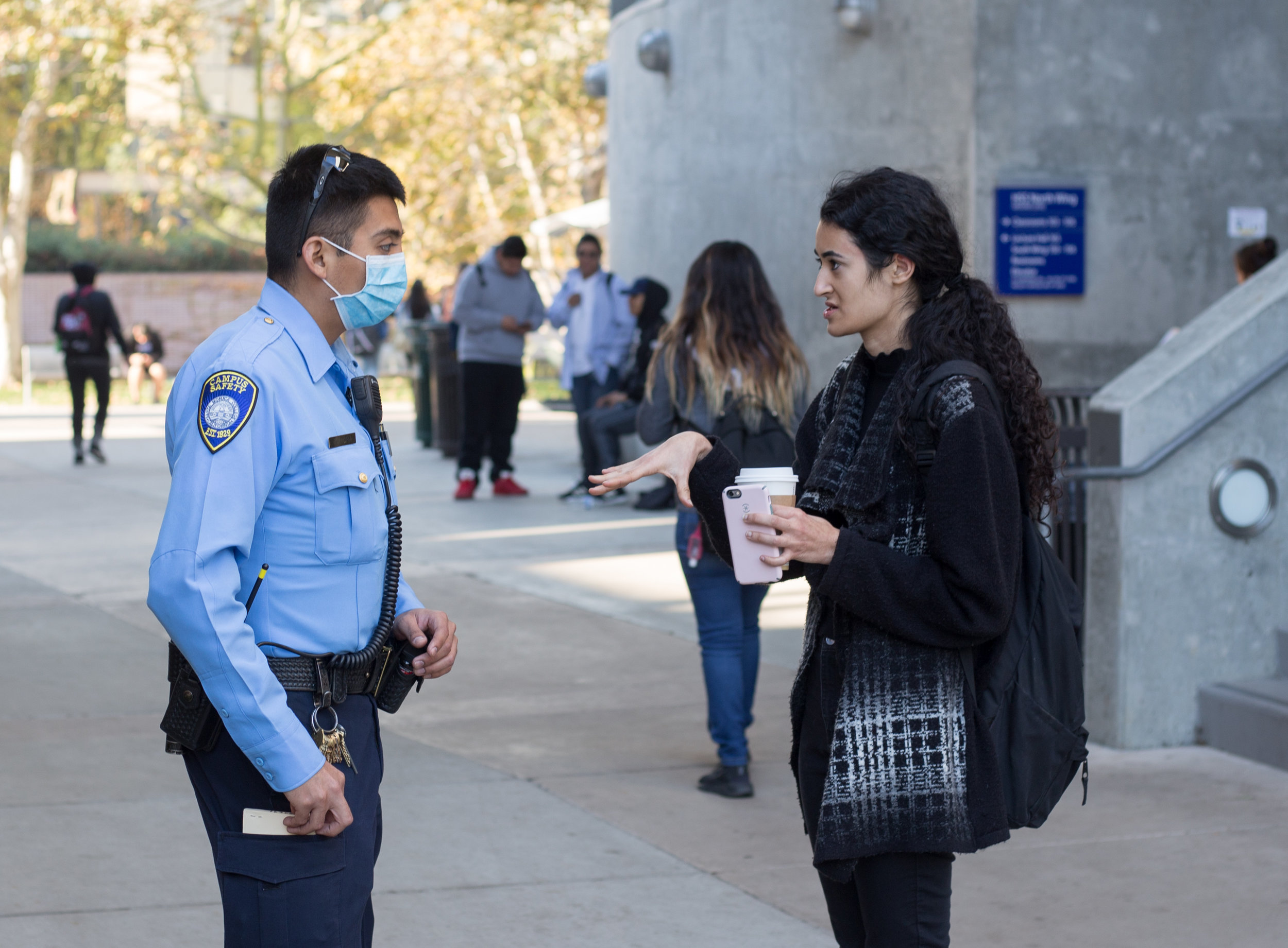  A Santa Monica Student (right) asks Campus Safety Officer Zamora (left) about why all classes were canceled after an email was sent out at 8:49 am by SMC informing students that classes are canceled due to the close proximity to the Skirball fire on