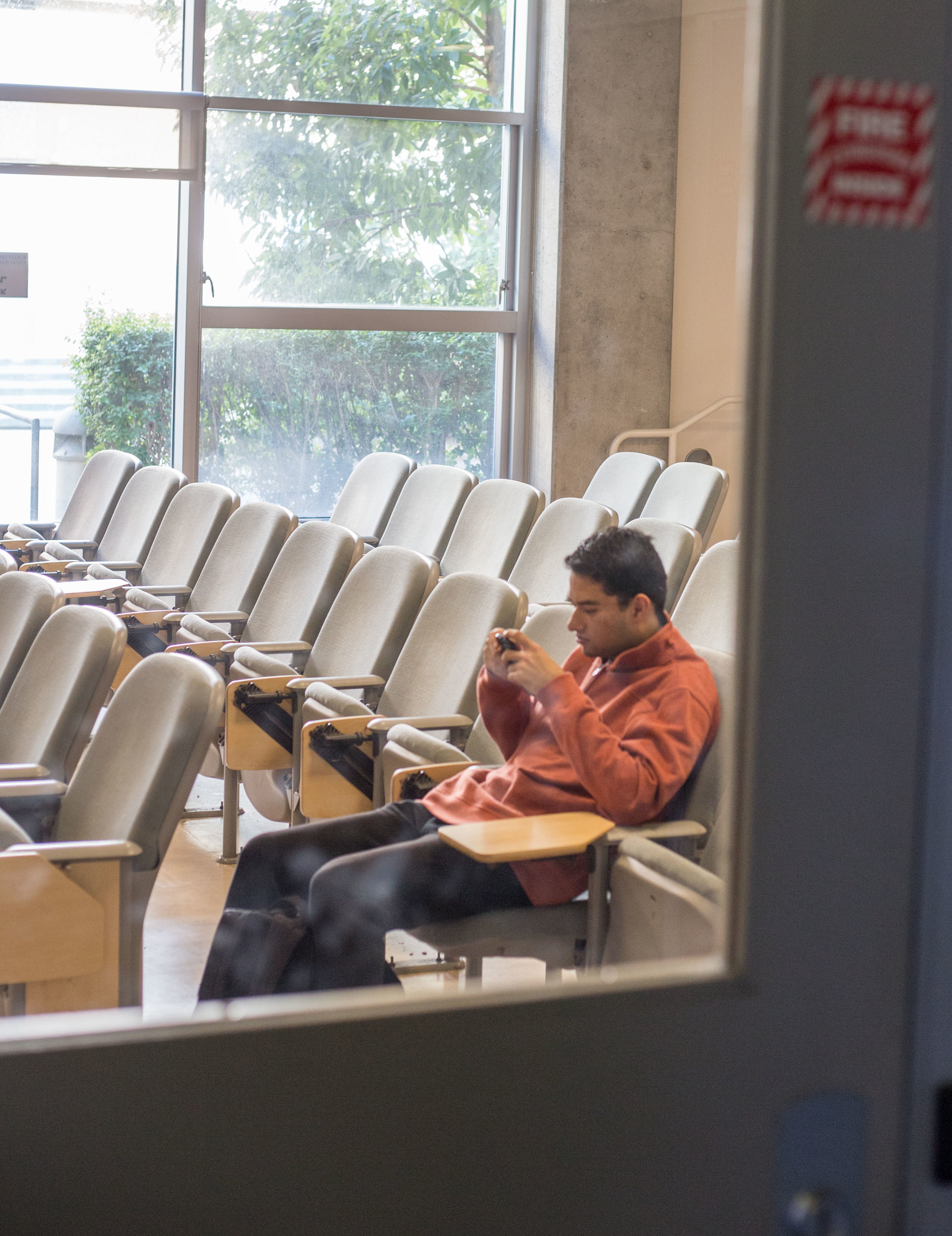  Santa Monica College student, refused to give name, sits alone in a classroom after SMC students were notified via email and phone call that all classes on Wednesday, December 6th were canceled due to the close proximity to the Skirball fire. This t