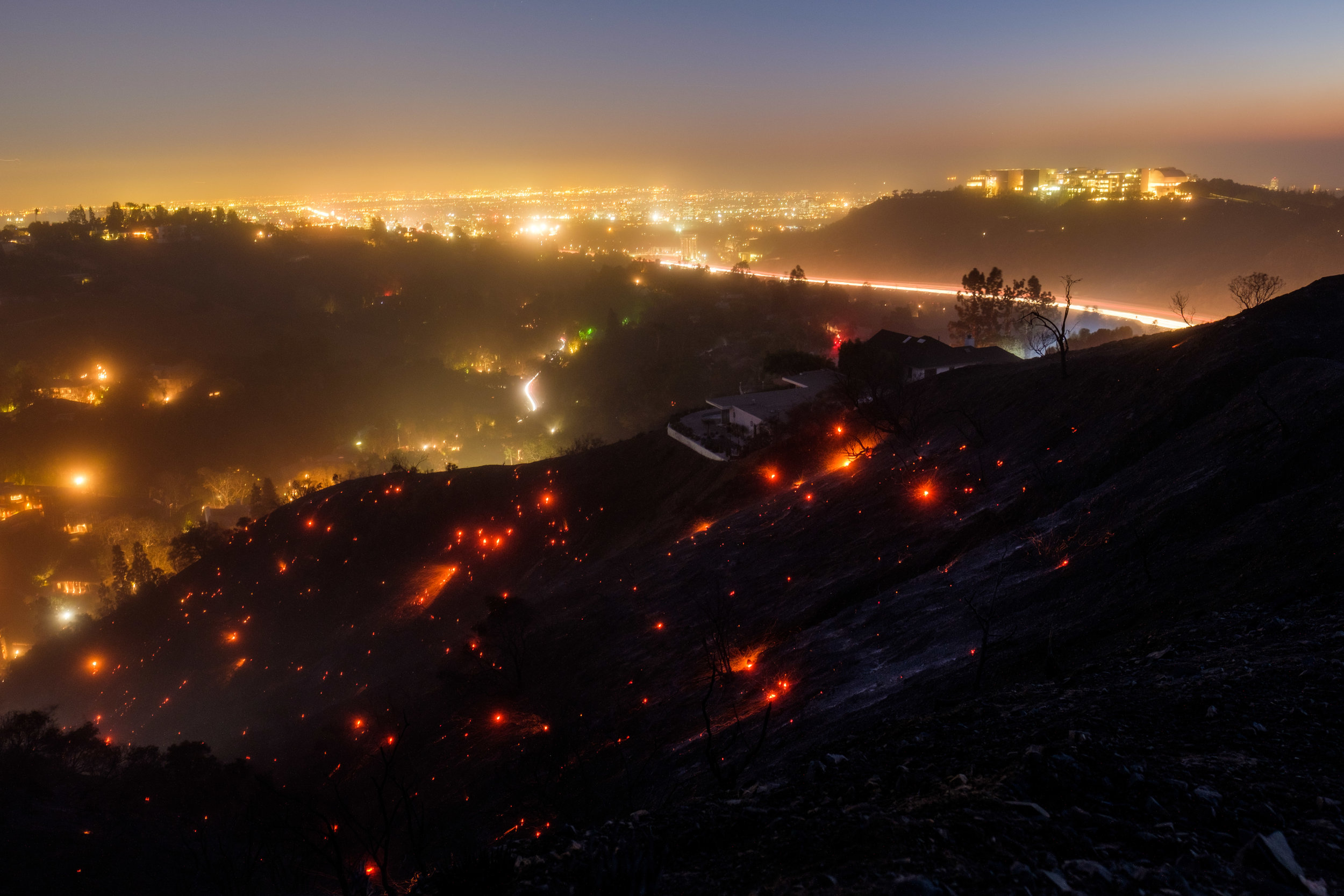  After sundown, the winds start to pick up on the Getty View Trail and embers from the Skirball Fire that burned down 475 acres of land at Sepulveda Pass. The fire started in the early morning and began to glow again in Santa Monica, Calif. On Dec. 6