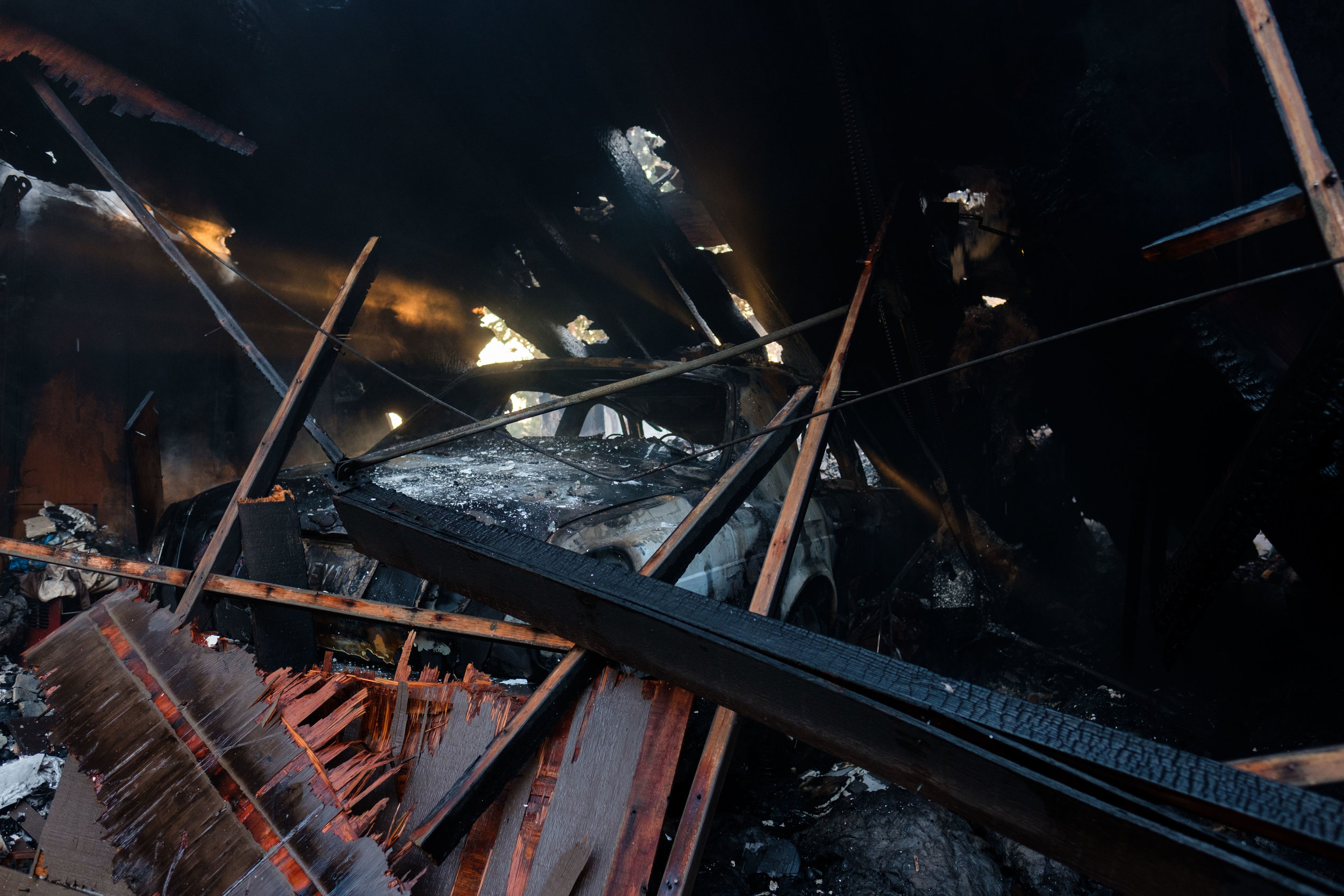  A garage collapsed on top of a Bentley, caused by the Skirball Fire in Los Angeles, Calif. On Dec. 6, 2017. (Photo by Jayrol San Jose) 