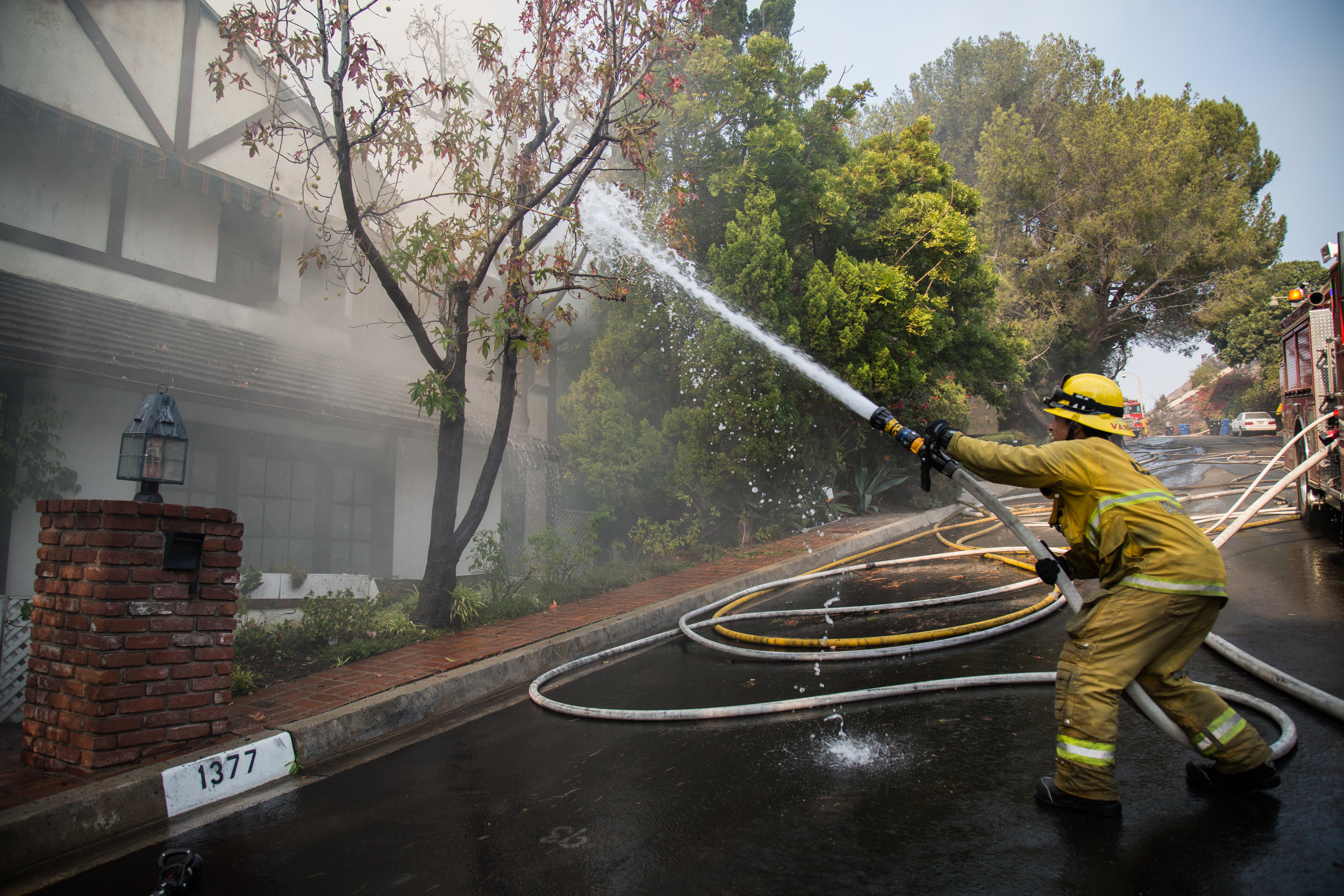  Luis Vargas, Los Angeles Fire Department, Class 1, Station 71, splashes the water to the house caught on fire on Wednesday, Dec. 6, 2017 at Casiano Boad in Bel Air, Los Angeles in California. (Photo by Yuki Iwamura) 