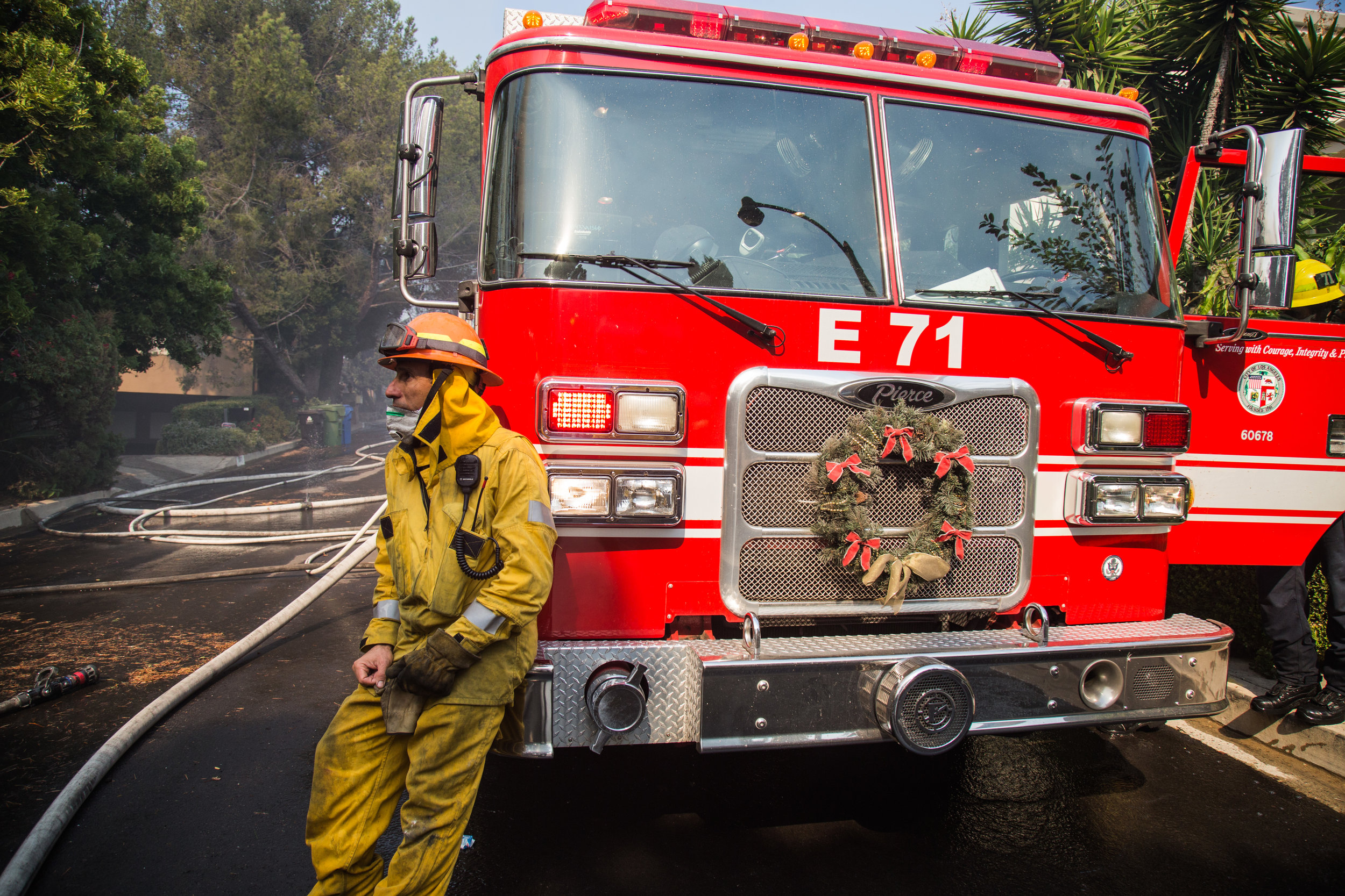  David Valadez, Los Angeles Fire Department, Class 1, Station 71 lean against their fire trucks. Firefighters arrived there at 4am, and they fights for straight over 10 hours. On Wednesday, Dec. 6, 2017. (Photo by Yuki Iwamura) 