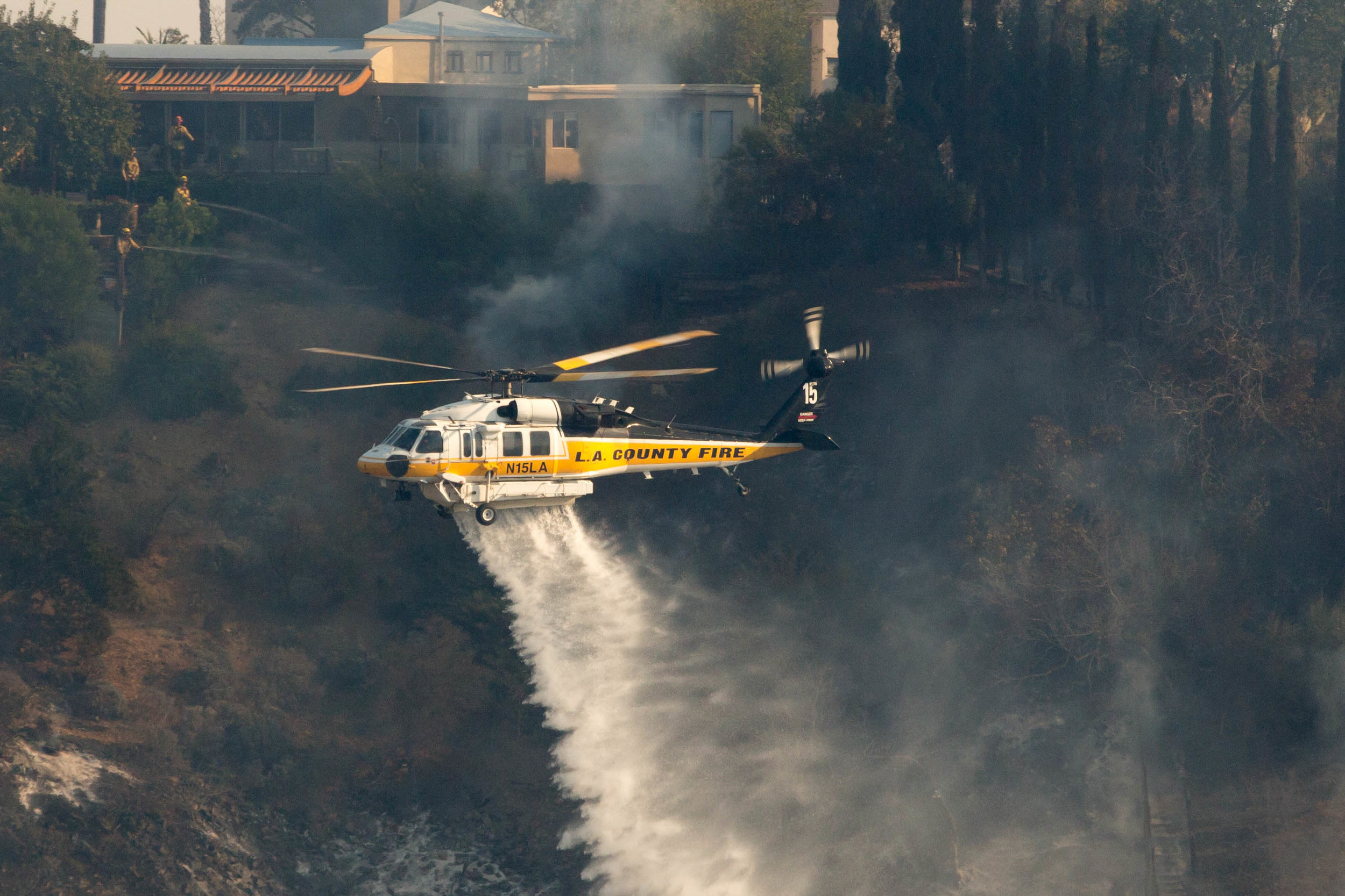  A Los Angeles County Fire helicopter makes a water drop on a vineyard during the Skirball Fire as firefighters on the ground work to keep the fire away on Wednesday, Dec.&nbsp;6, 2017 in the Bel-Air area of Los Angeles, Calif. (Jose Lopez) 