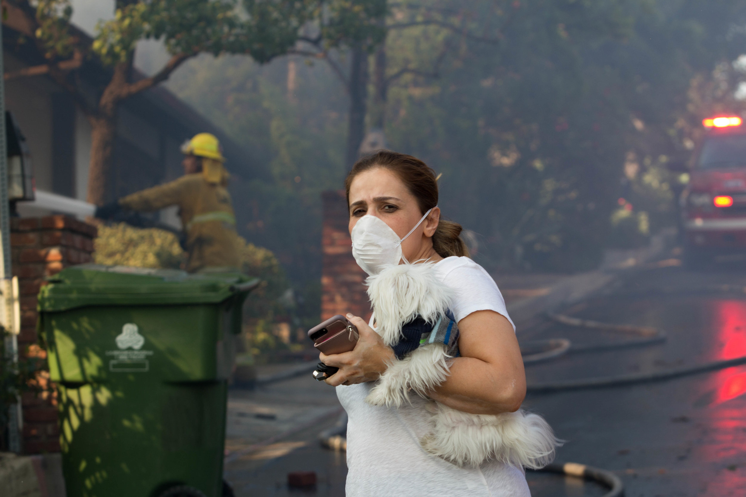  A distraught resident evacuates from her home along Casiano Road with her pet during the Skirball Fire on Wednesday, Dec.&nbsp;6, 2017 in Los Angeles, California. (Jose Lopez) 