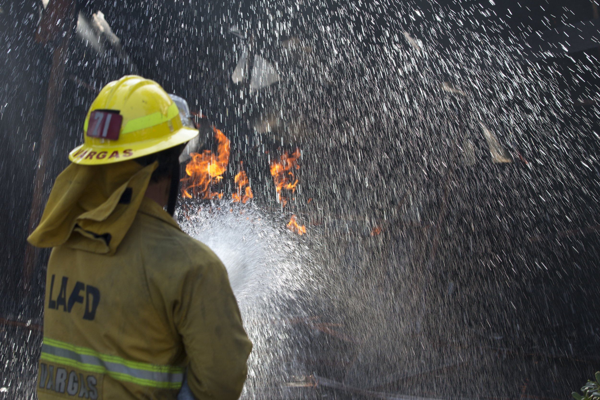  Los Angeles City firefighter Luis Vargas, from Engine 71, sprays down a car on fire inside a garage on Casiano Road during the Skirball fire on Wednesday, Dec.&nbsp;6, 2017 in the Bel-Air area of Los Angeles, Calif. (Jose Lopez) 