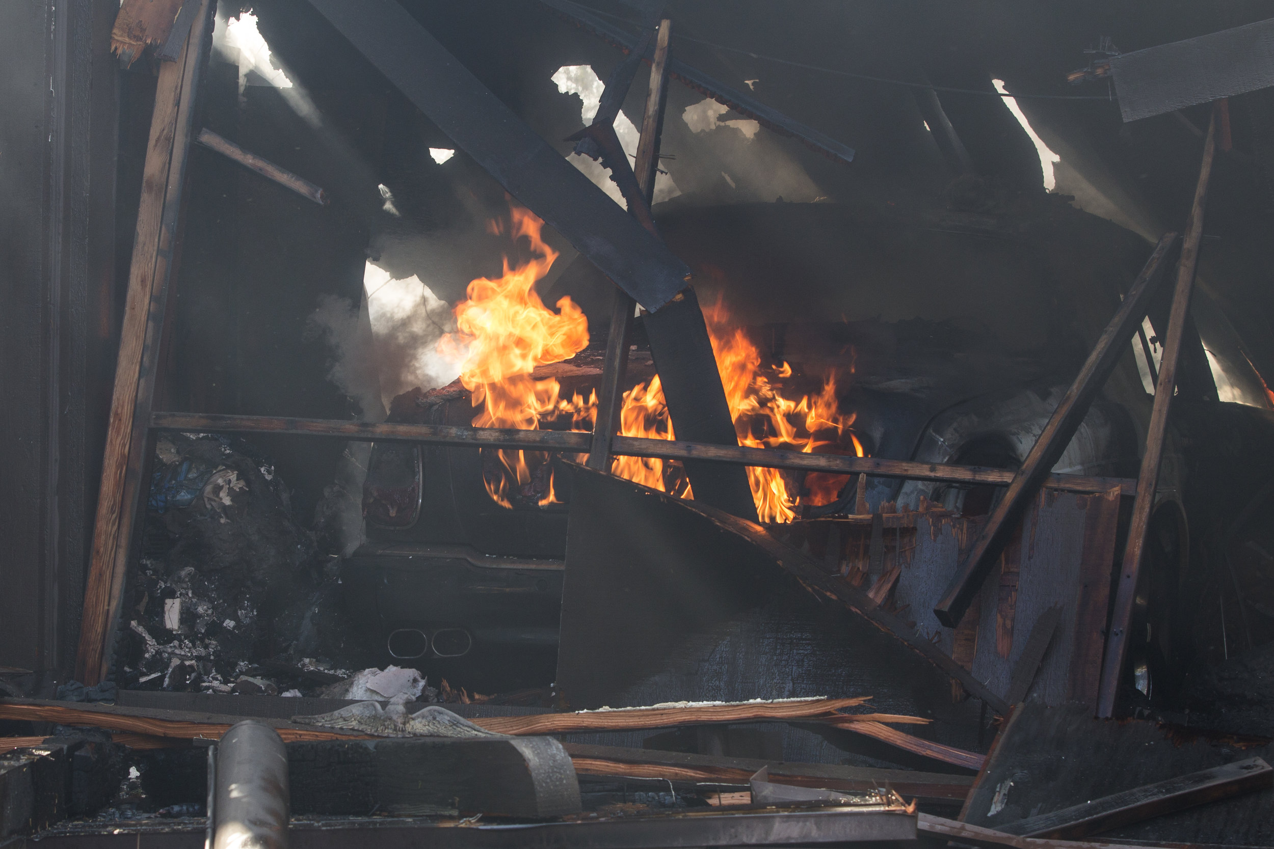  A car burns in the garage port of a home on Casiano Road that was hit by the Skirball Fire on Wednesday, Dec.&nbsp;6, 2017 in the Bel-Air area of Los Angeles, Calif. (Jose Lopez) 