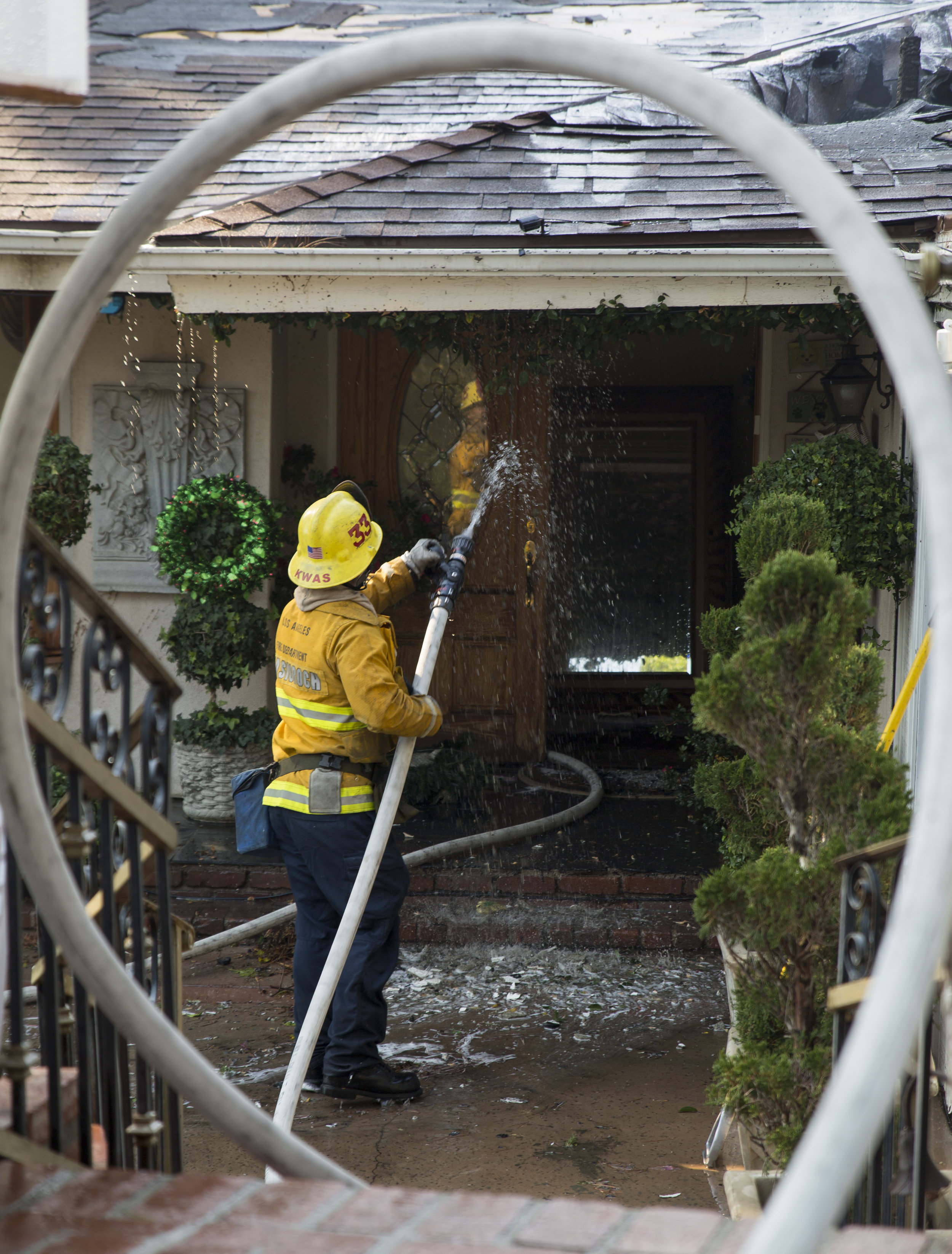  Los Angeles City firefighters fight to save one of the two homes on fire along Casiano Road in Bel-Air during the Skirball Fire on Wednesday, Dec.&nbsp;6, 2017 in Los Angeles, Calif. (Photo by Jose Lopez) 