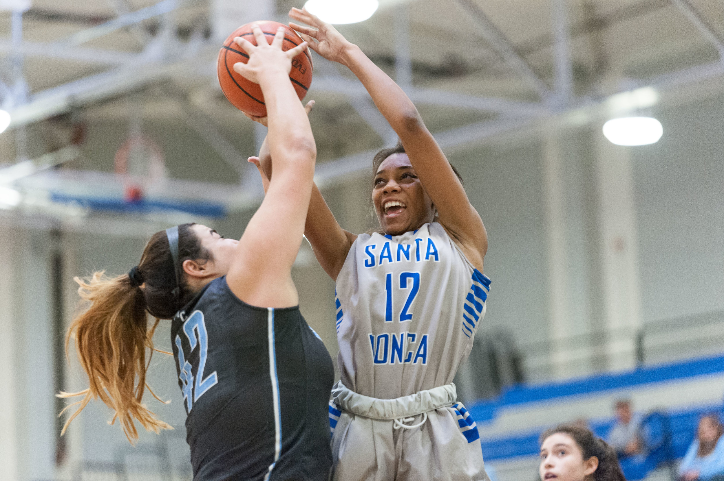  Forward Jazzmin Oddie (12,Right) of Santa Monica College attempts to shoot a contested jumpshot but is blocked by center Barbara Rangel (42,Left) of Moorpark College. The Santa Monica College Corsairs lose the game 52-69 to the Moorpark College Raid