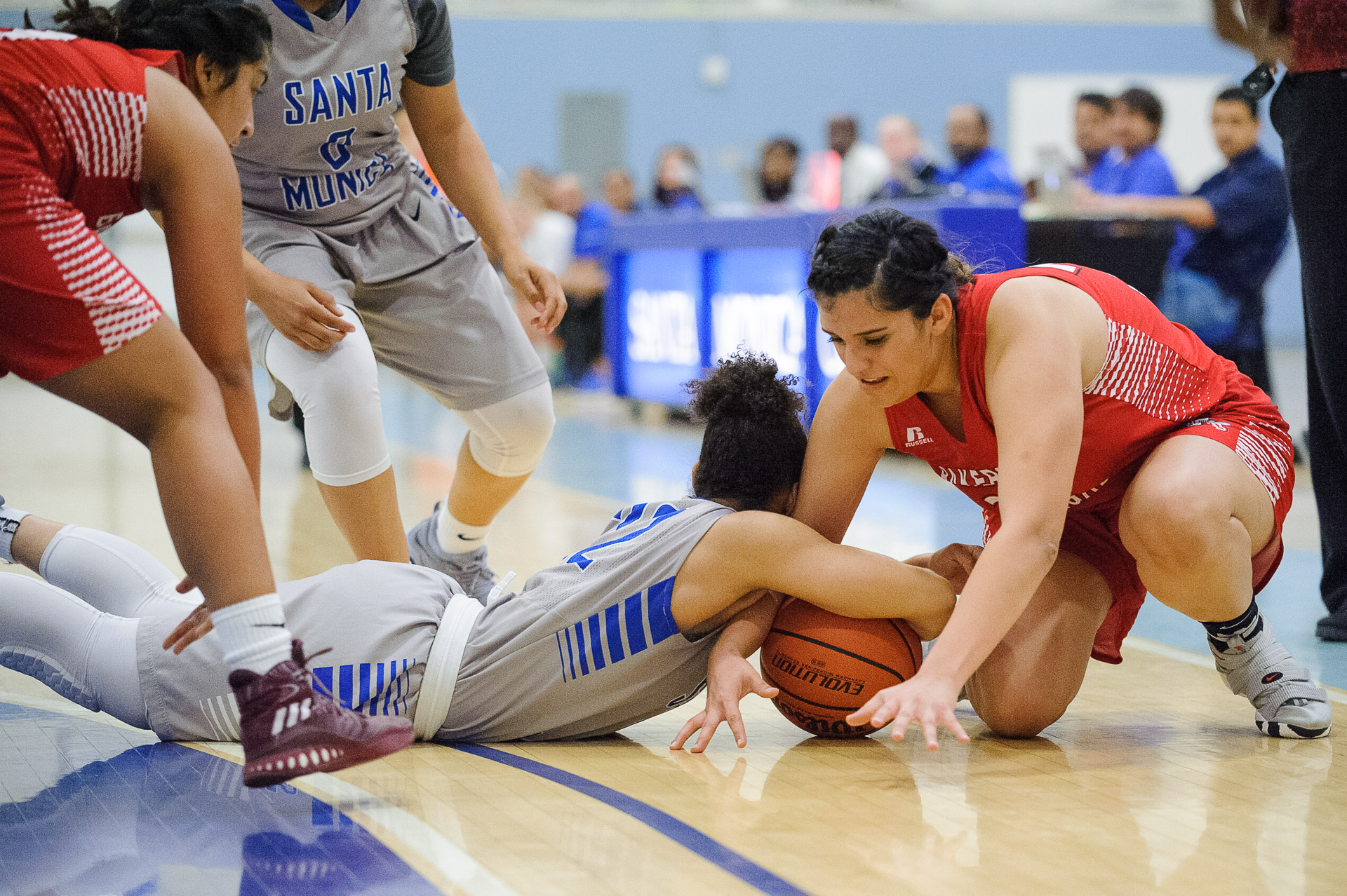  Guard Jinea Cole (22,Middle) of Santa Monica College fights for a loose ball against Brianna Mendez (24,Right) of Bakersfield College. The Santa Monica College Corsairs lose the game 62-72 to the Bakersfield College Renegades. The game was held at t