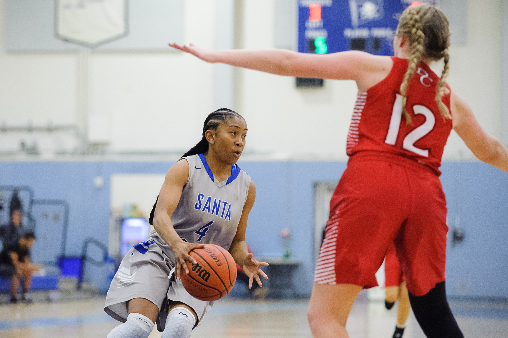  Guard Lisa Hall (4,Left) of Santa Monica College prepares to make a pass while being guarded by Angie Kroeger (12,Right) of Bakersfield College. The Santa Monica College Corsairs lose the game 62-72 to the Bakersfield College Renegades. The game was