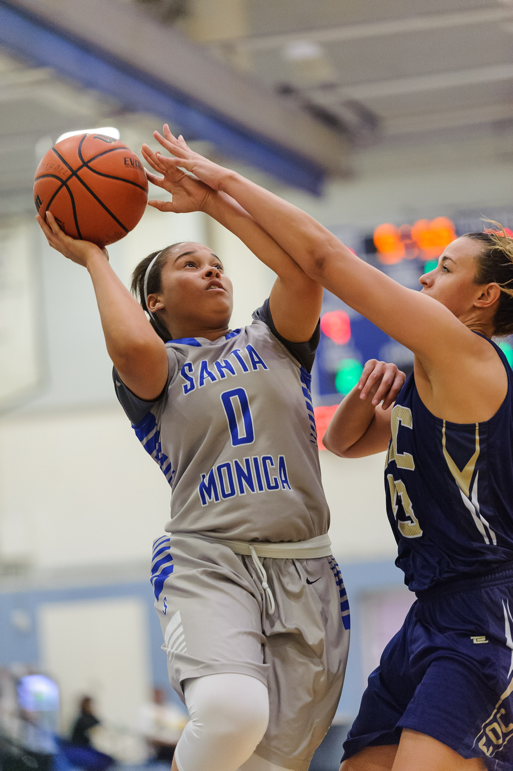 Rejinae Crandell (0,Left) of Santa Monica College goes up for a shot while contested by Kalana Inemer (43,Right) of the Canyons. The Santa Monica College Corsairs lose the game 108-70 to the College of the Canyons Cougars. The game was held at the S