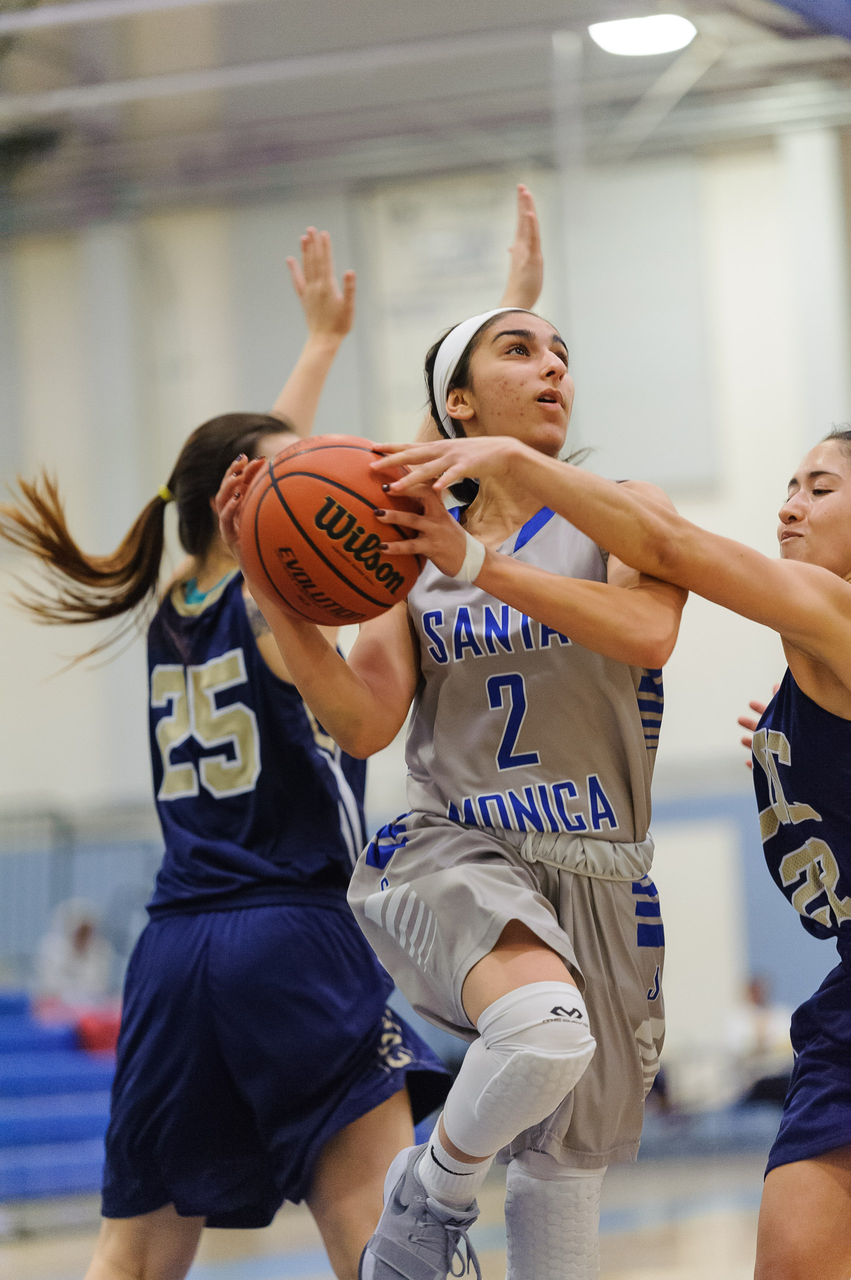 Guard Jessica Melamed (2,Middle) of Santa Monica College goes up for a layup attempt as Alexis Orellana (22,Right) of the College of the Canyons attempts to strip the ball from Melamed. The Santa Monica College Corsairs lose the game 108-70 to the C
