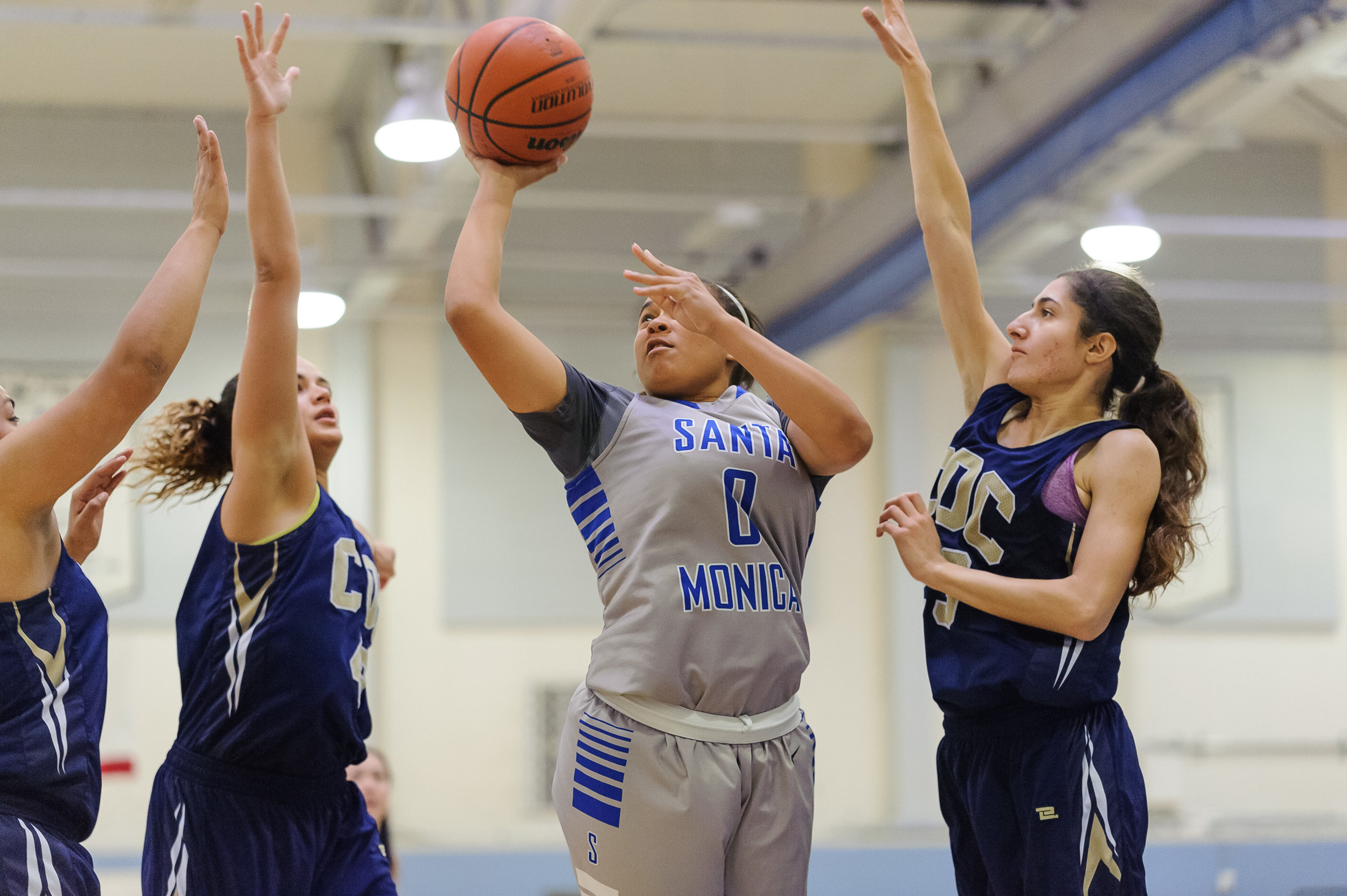  Rejinae Crandell (0,Middle) of Santa Monica College shoots a shot in the lane while swarmed by the College of the Canyons defense. The Santa Monica College Corsairs lose the game 108-70 to the College of the Canyons Cougars. The game was held at the