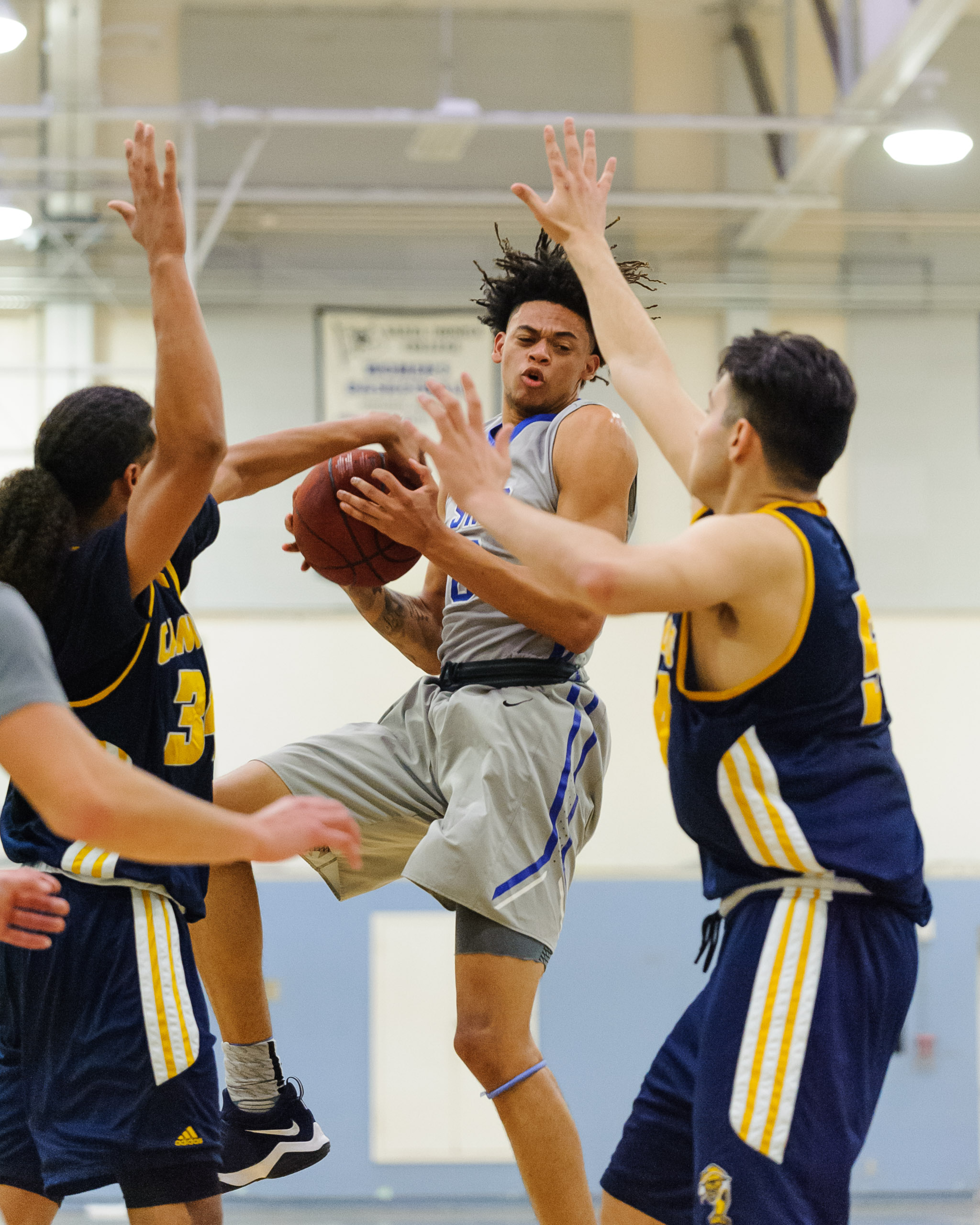  Forward Michael Fry (0) of Santa Monica College grabs an offensive rebound in traffic. The Santa Monica College Corsairs lose the game 74-72 to the College of the Canyons Cougars. The game was held at the SMC Pavilion at the Santa Monica College Mai