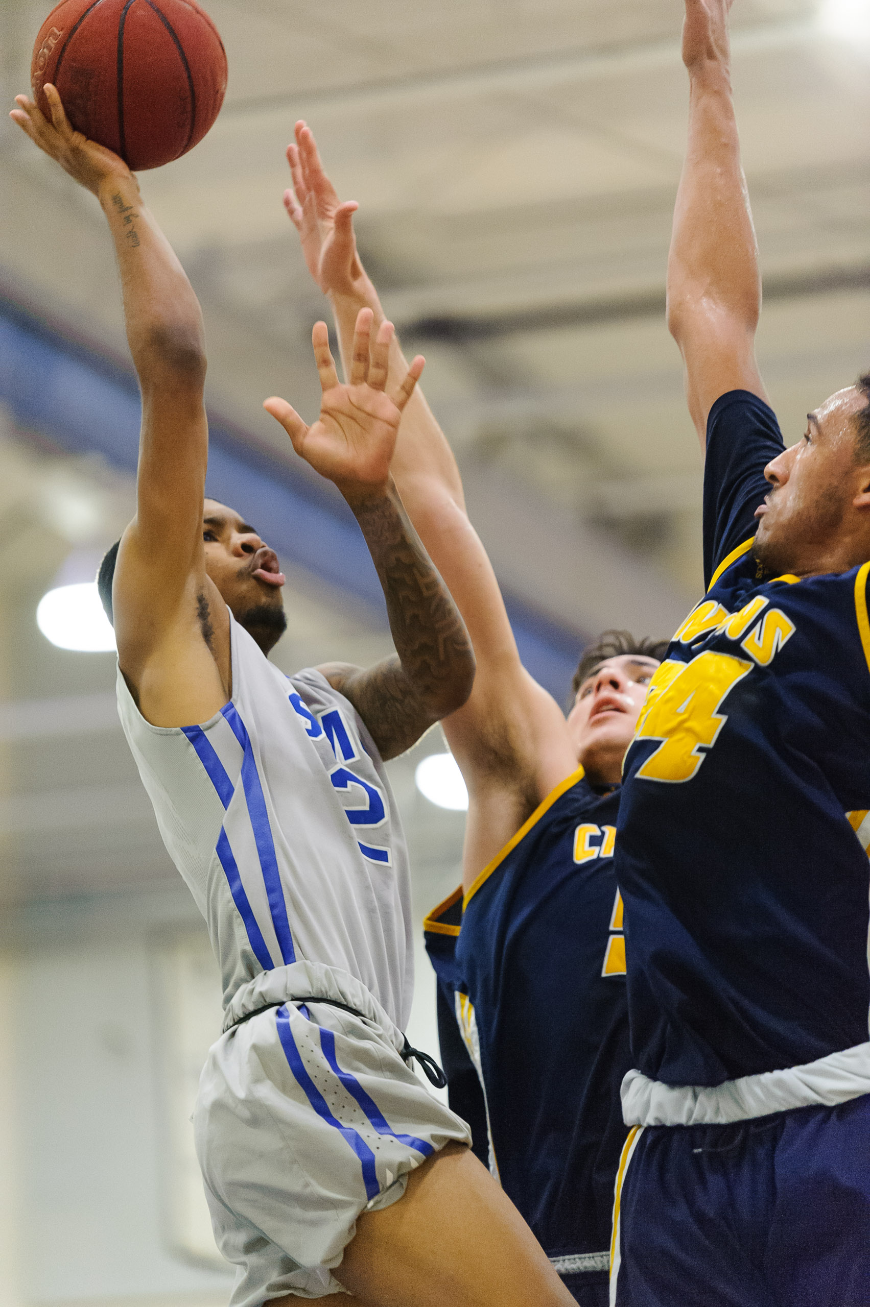  Guard Joe Robinson (2) of Santa Monica College shoots a floater while contested by the College of the Canyons defense. The Santa Monica College Corsairs lose the game 74-72 to the College of the Canyons Cougars. The game was held at the SMC Pavilion