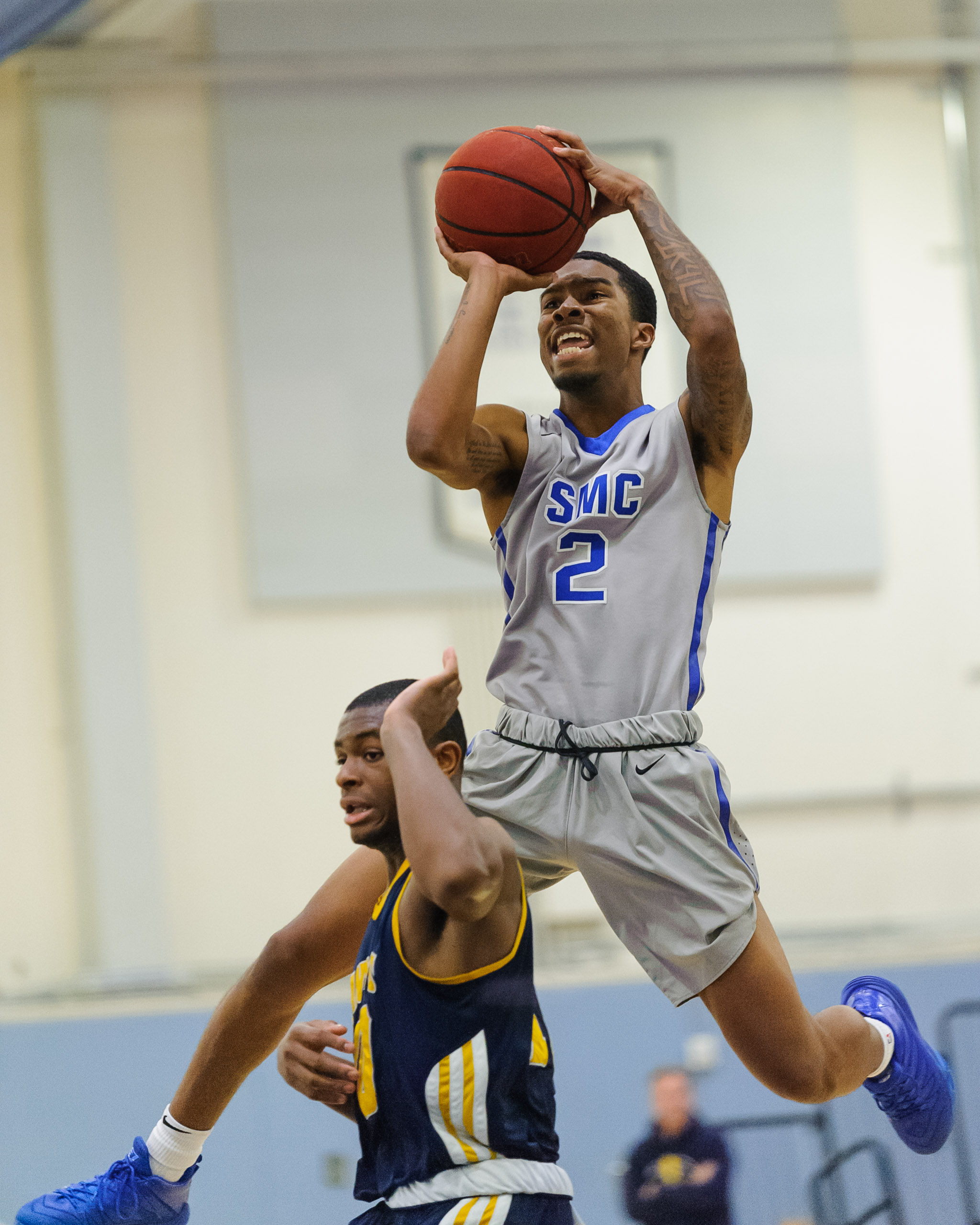  Guard Joe Robinson (2,Right) of Santa Monica College draws a shooting foul on the College of the Canyons defense. The Santa Monica College Corsairs lose the game 74-72 to the College of the Canyons Cougars. The game was held at the SMC Pavilion at t