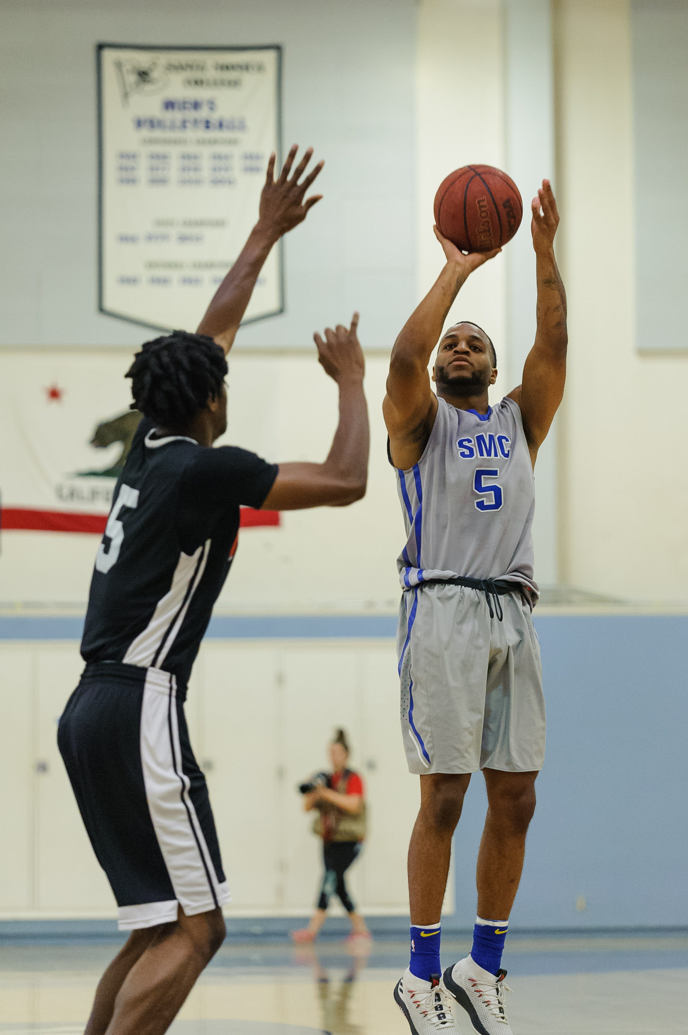  Forward Jhamad Norwood (5) of Santa Monica College takes an three pointer on a late contest by the Pierce College defense. The Santa Monica Corsairs lose their final game of the season 103-91 to the Pierce College Brahmas. The game was held at the S