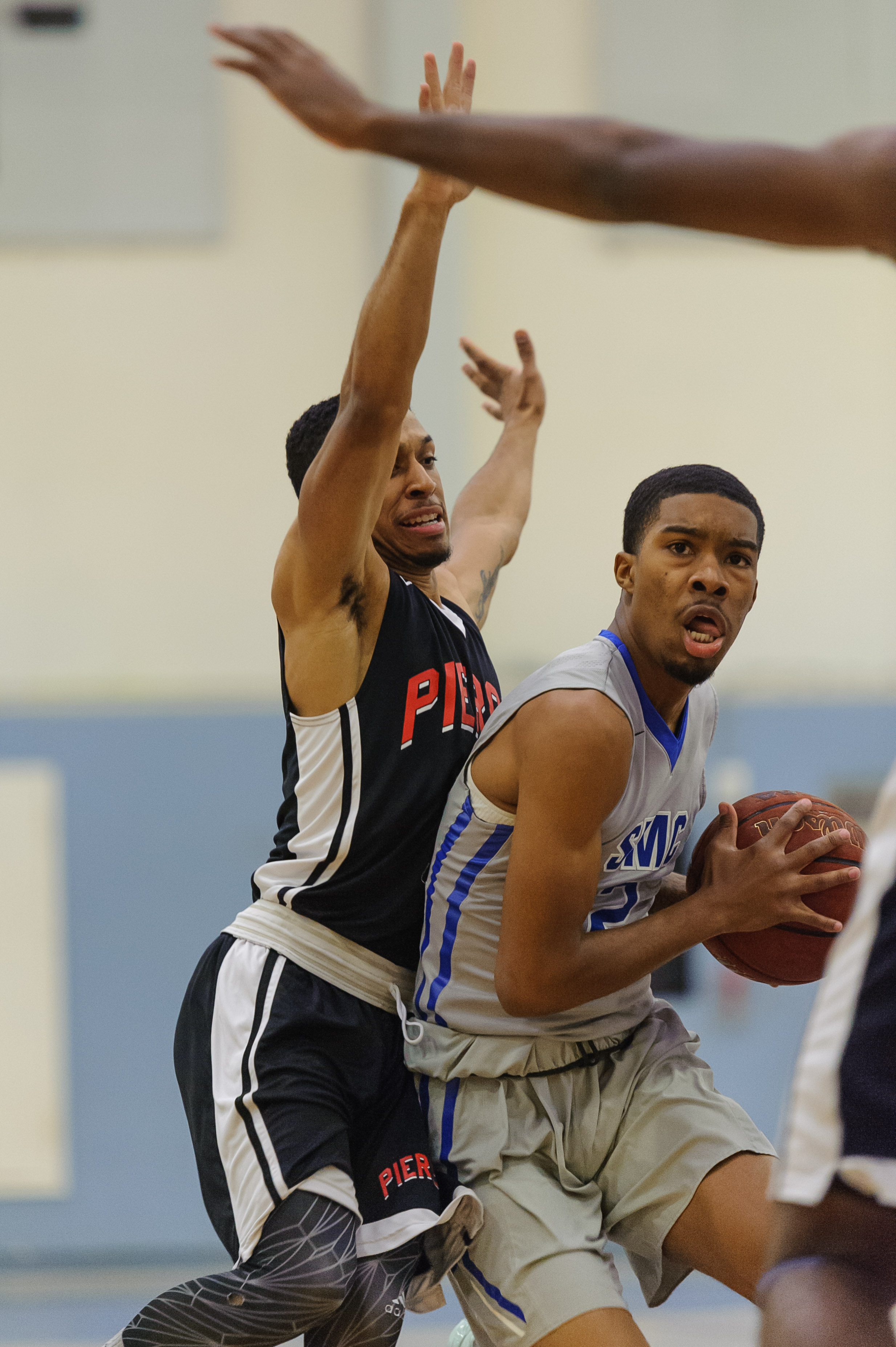  Guard Joe Robinson (2,Right) of Santa Monica College drives into the lane while guarded by G.O. White (0,Left) of Pierce College. The Santa Monica Corsairs lose their final game of the season 103-91 to the Pierce College Brahmas. The game was held a