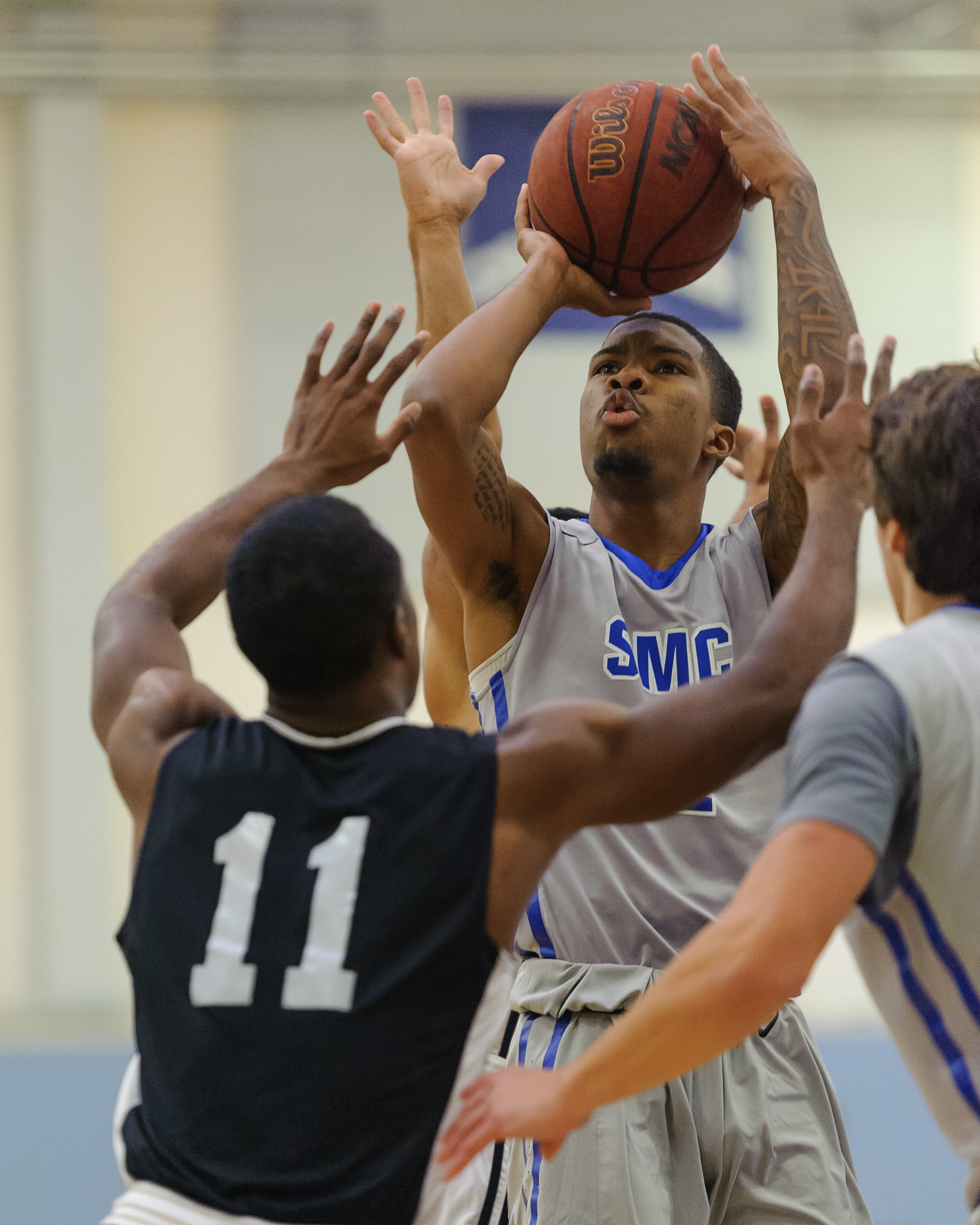  Guard Joe Robinson (2,Right) of Santa Monica College takes a jumpshot while contested by John Flowers (11) of Pierce College. The Santa Monica Corsairs lose their final game of the season 103-91 to the Pierce College Brahmas. The game was held at th