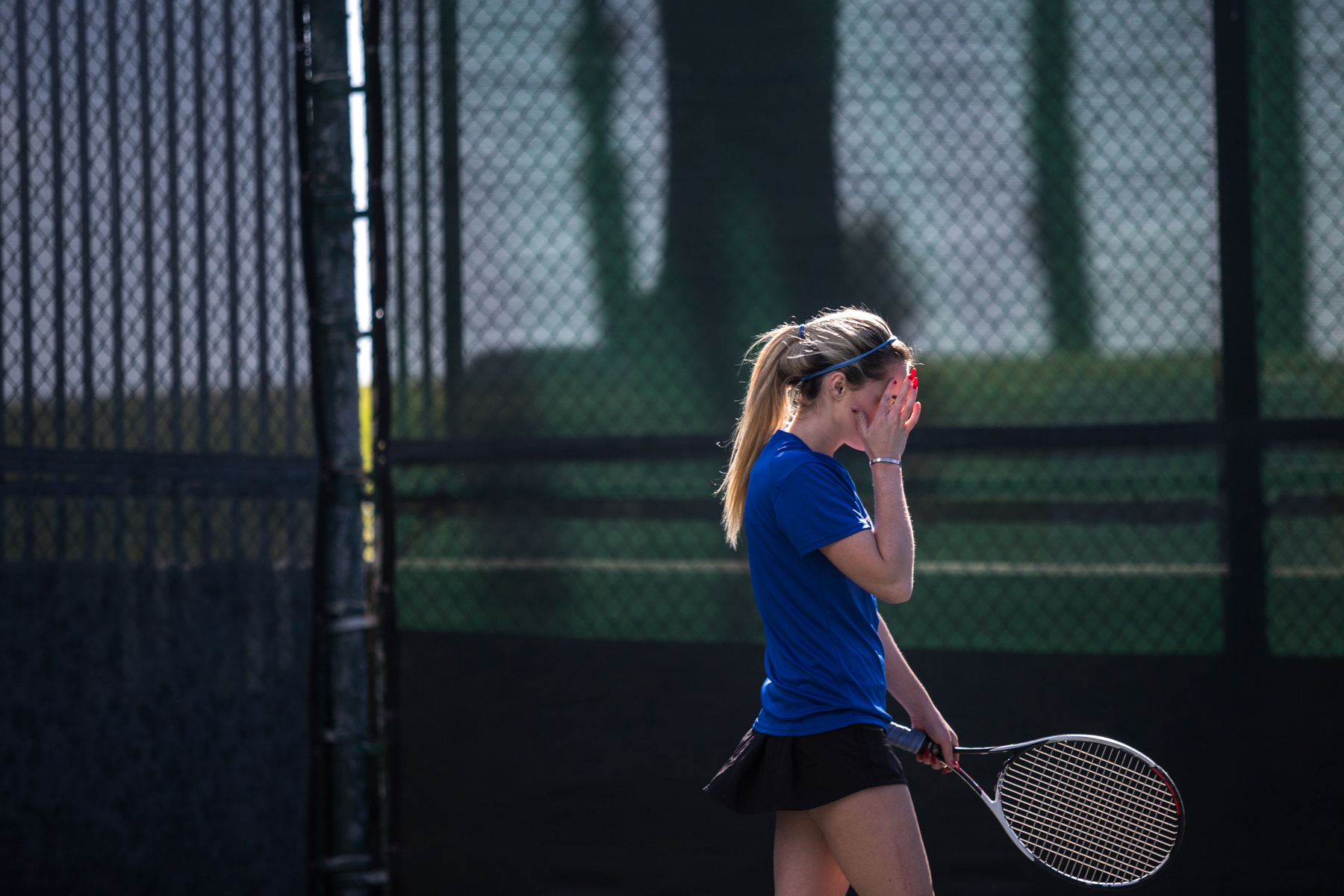  Santa Monica College Corsair freshman Abby Mullins (#1, singles) grabs her face in frustration as she loses a game during her 2–0 (6-2, 6-1) set victory, which was part of the Corsairs 7–1 victory against the Ventura College Pirates at the Ocean Vie