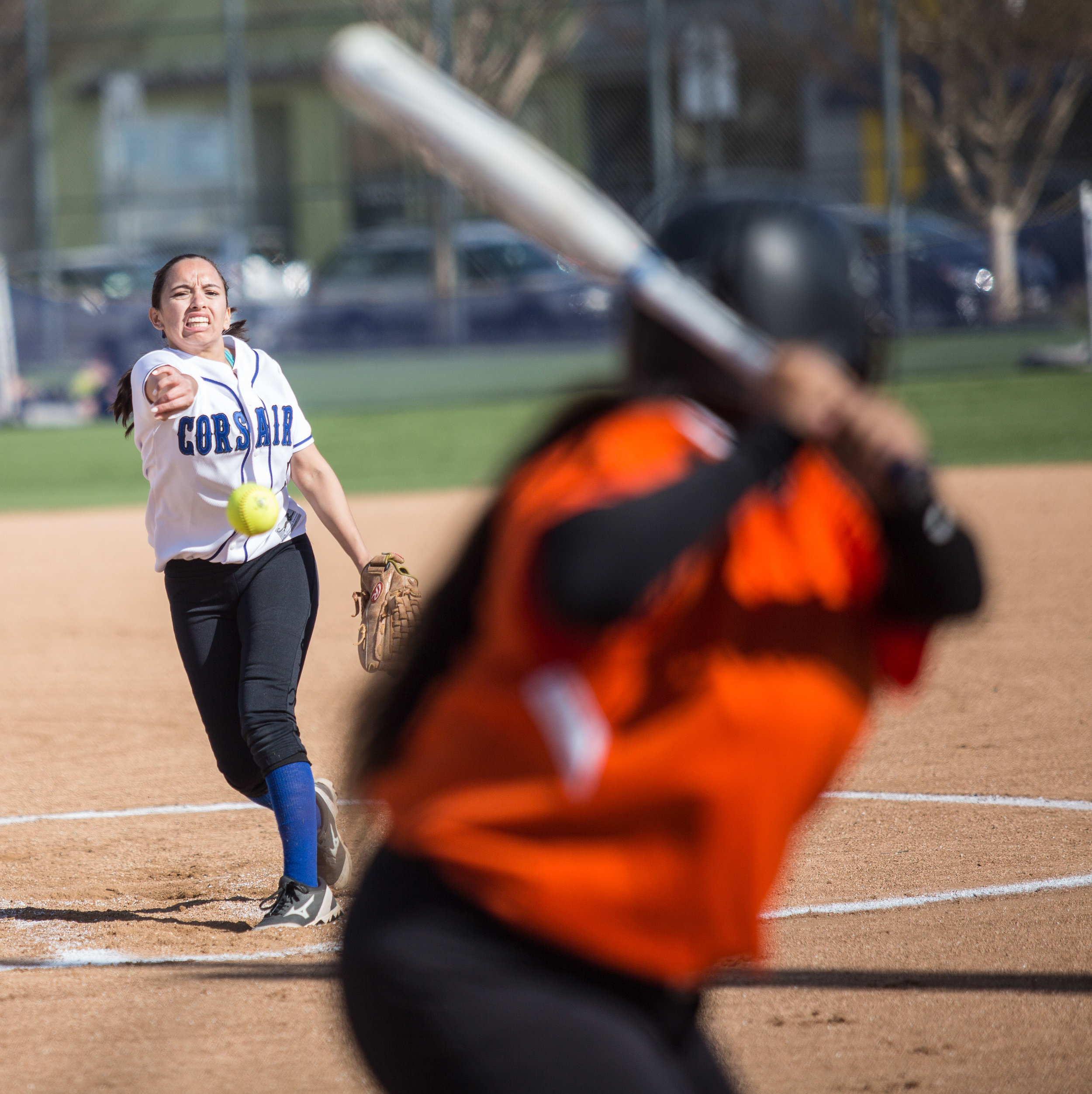  Santa Monica College Corsair freshman outfielder Cheryl Thomas #3(white, left) pitches a curve ball during the bottom of the 1st the ball at her Ventura College Pirate opponent at the Corsair Field in Santa Monica California, on Tuesday, February 27