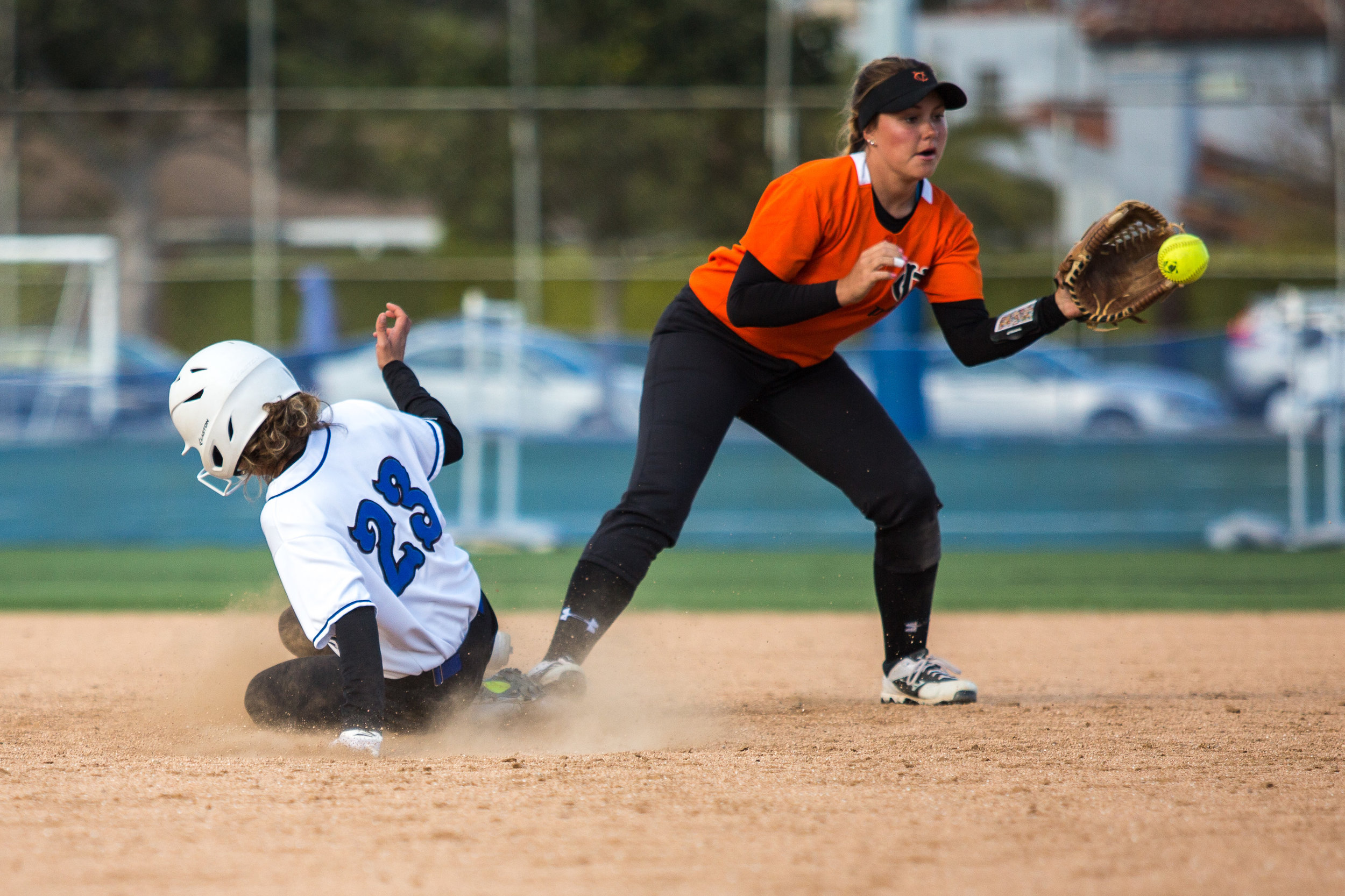  Santa Monica College Corsair freshman Taylor Liebesman #23 (left, white) successfully slides into 2nd base as Ventura College Pirate freshman second short stop Danielle Carmona #13 (right, red) receives the ball from in-field during the bottom of th