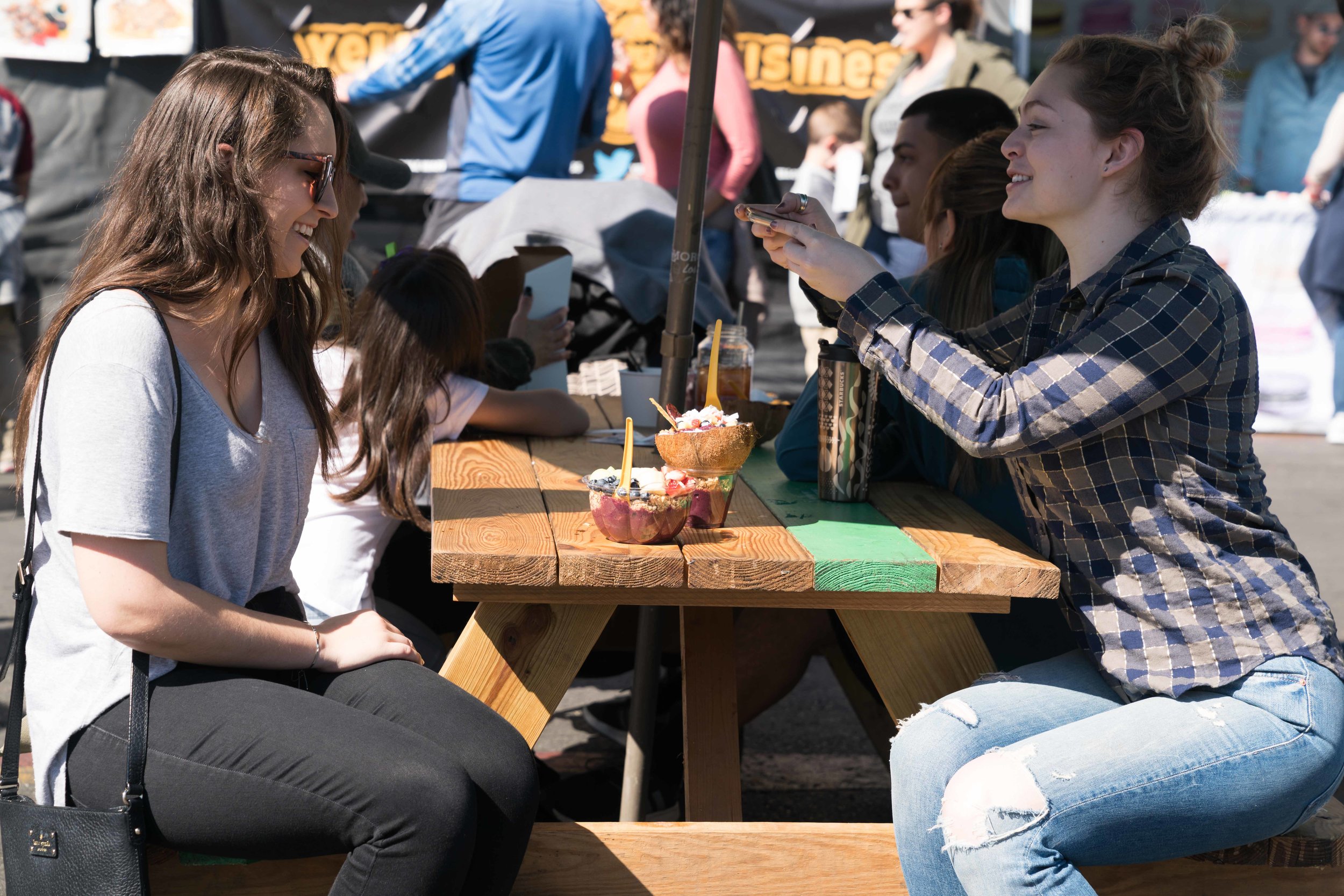  Amanda Slate (right) and Erika VonNovak (left) takes pictures of their coconut bowls from Amazeballs on Sunday, February 25, 2018 at Smorgasburg LA, a weekly food and vendor market on Sundays at Row DTLA. (Photo by Helena Sung) 