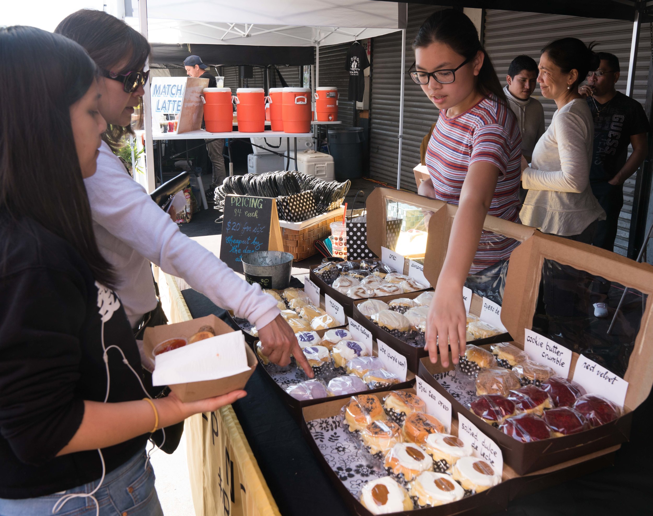  Natalie Reyes, 13, (on right) helps customers pick out different flavors of Filipino brioche buns at Smorgasburg LA in the downtown section of Los Angeles, Calif. Reyes' mother, Chari Reyes, is the owner of Ensaymada Project, a home-based business m