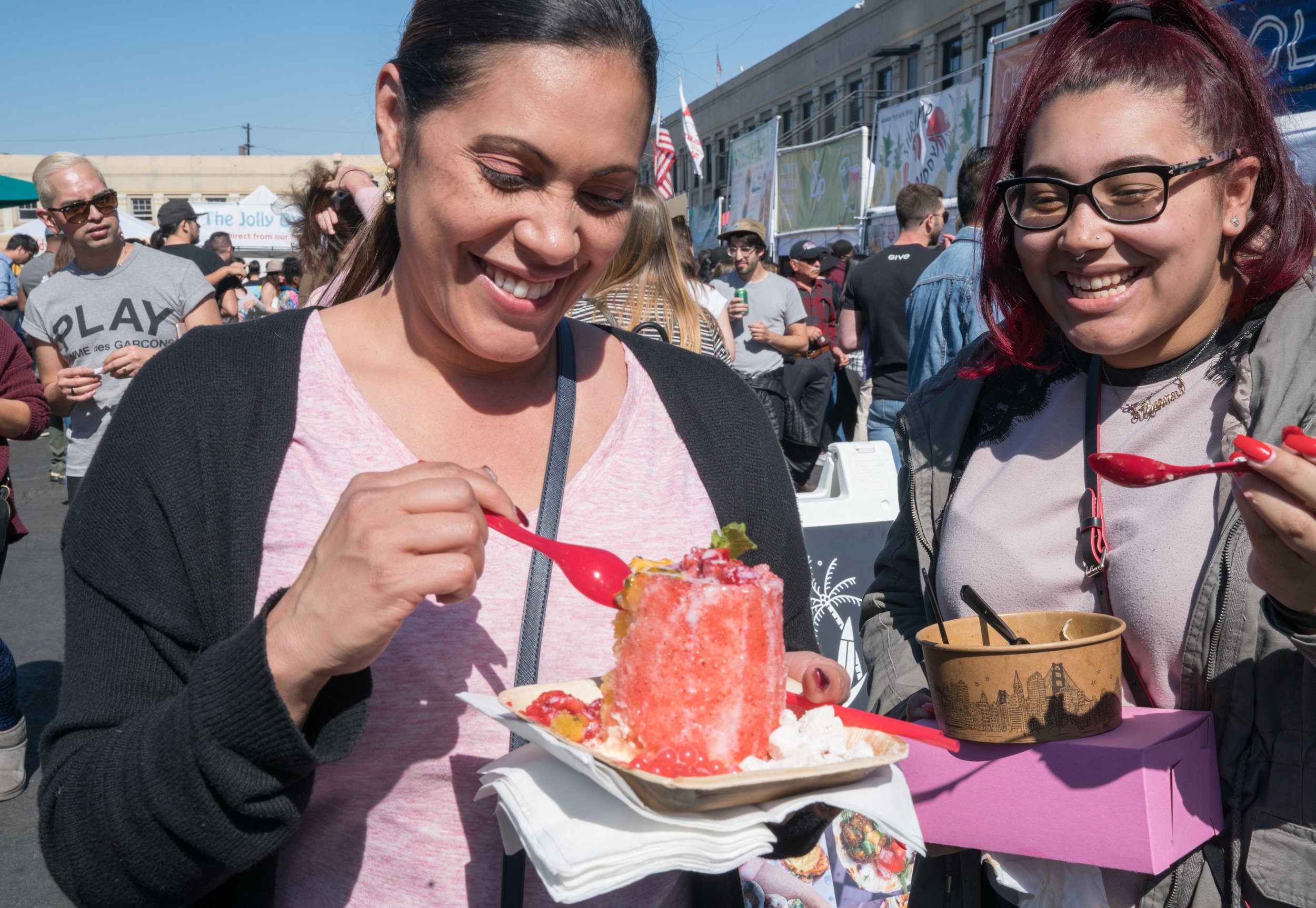  Analia Torres (left) and her daughter Alyanni Torres (right) eat Hawaiian shave ice with homemade mochi from Chichi Dango, a vendor at Smorgasburg LA in the downtown section of Los Angeles on Sunday, February 25, 2018. "It's really good," the mother